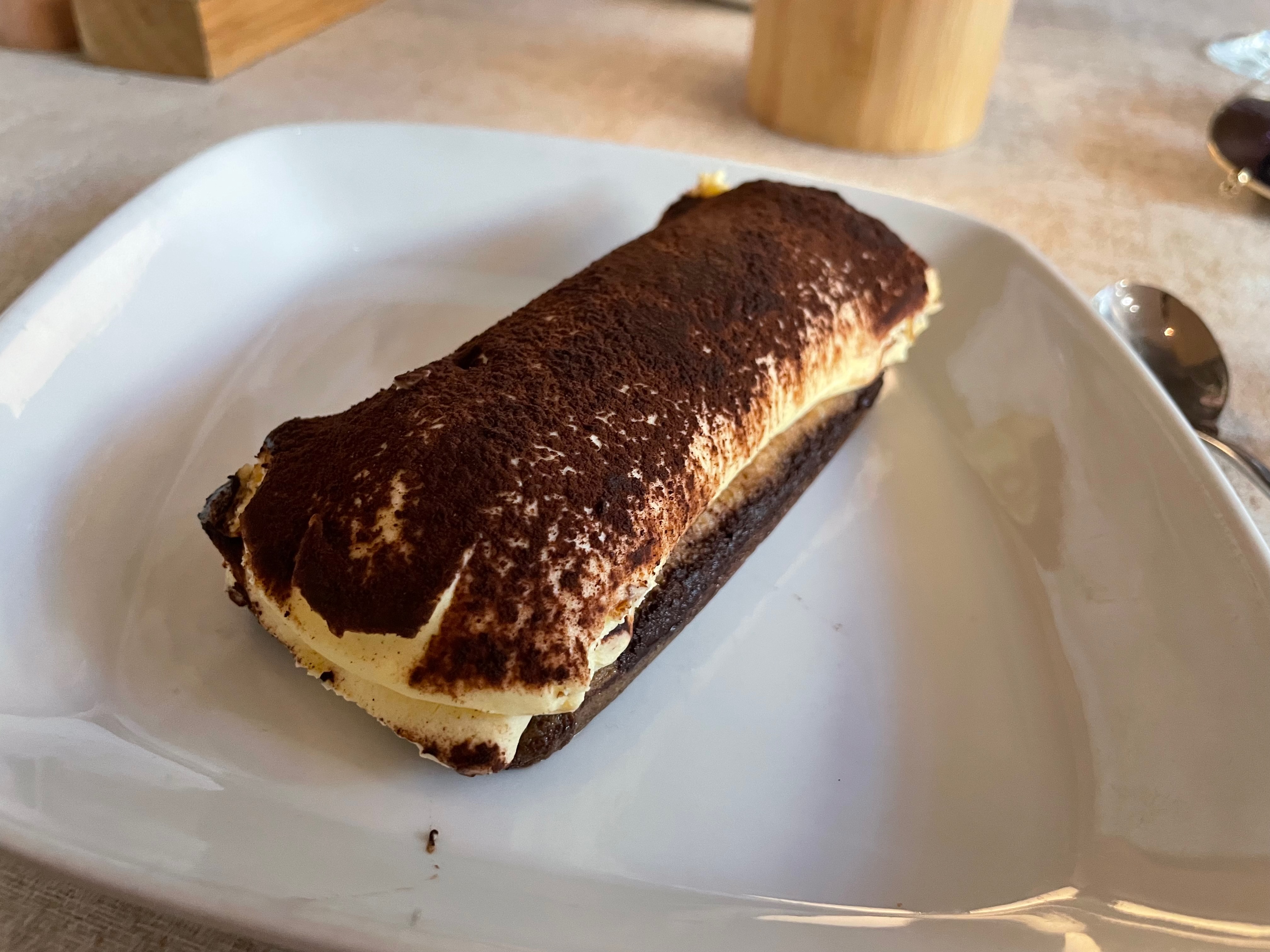 Jensens Bøfhus Kolding review tiramisu dessert served on a white plate, showing cocoa powder, cream filling, and a simple plated presentation at the former Kolding Storcenter restaurant