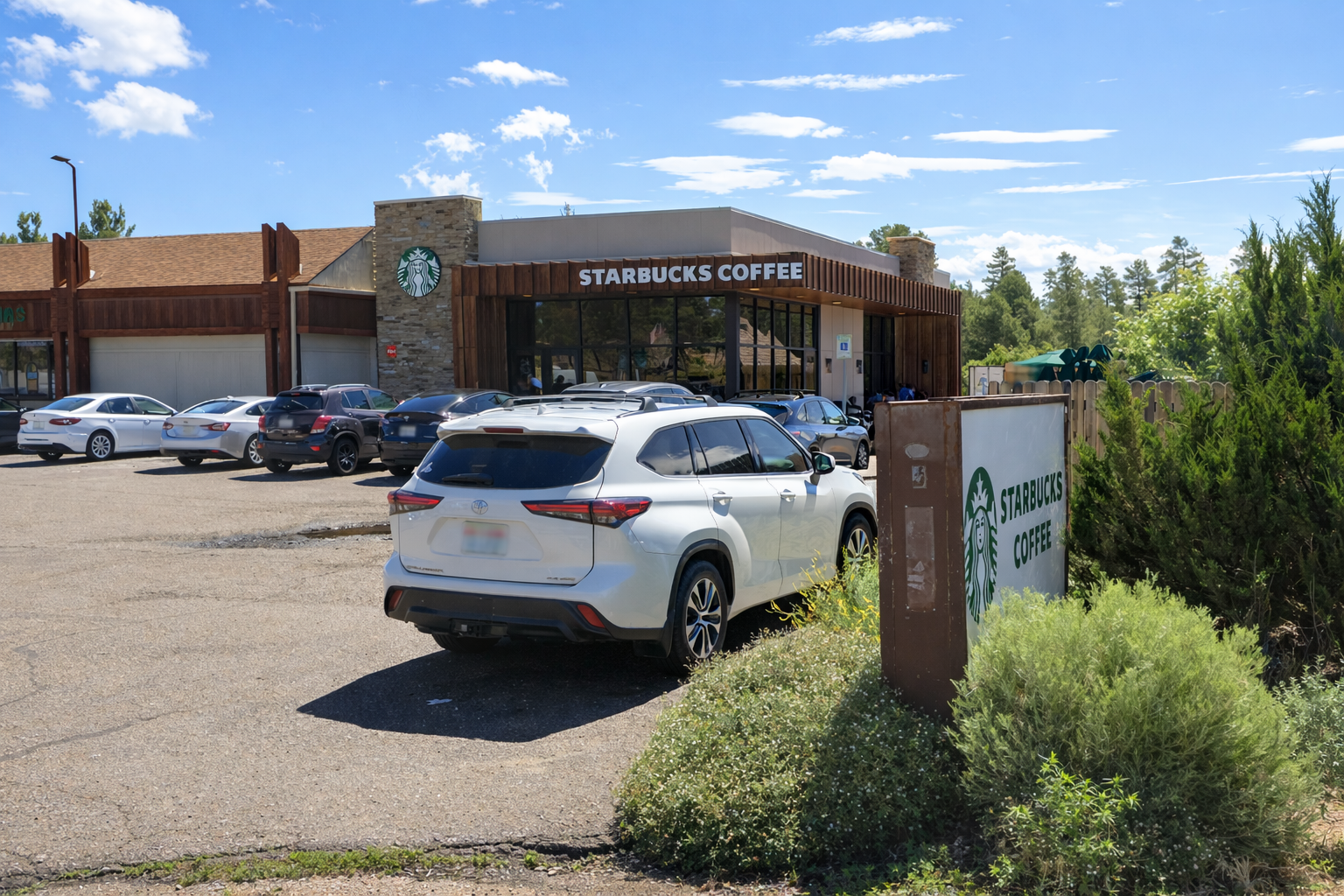 Starbucks near the Grand Canyon in Tusayan, Arizona, located at the Tusayan General Store along AZ-64, with outdoor seating and parked cars on a sunny day.
