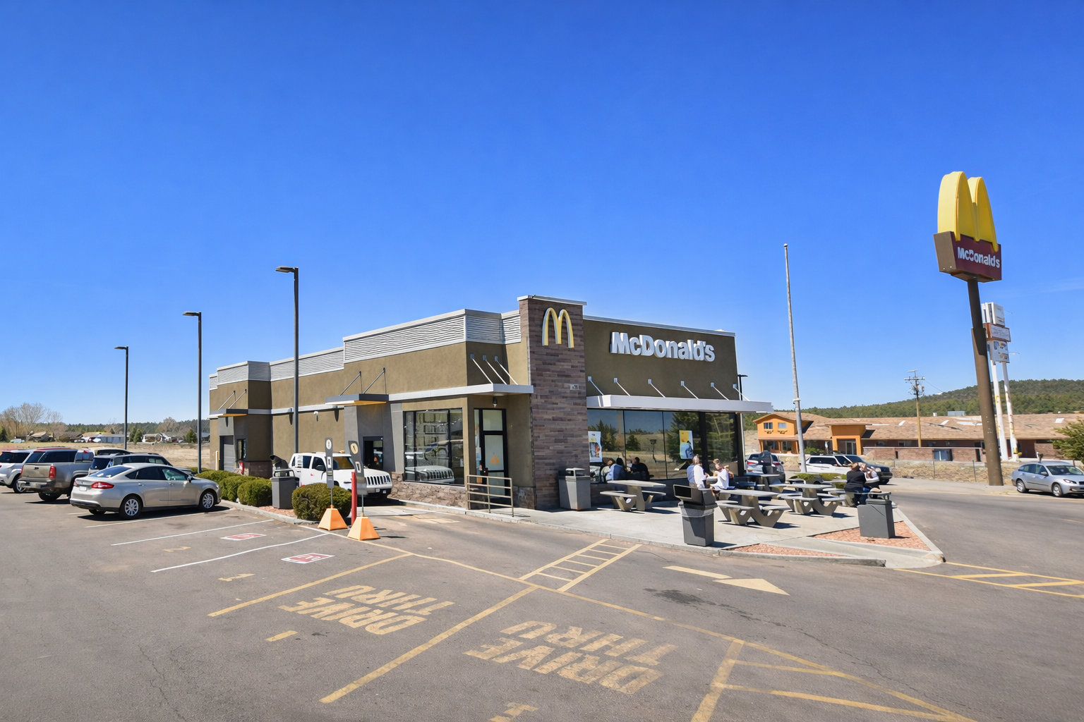 Exterior of McDonald’s in Williams Arizona along I 40 near Grand Canyon featuring outdoor seating drive in access and clear blue sky