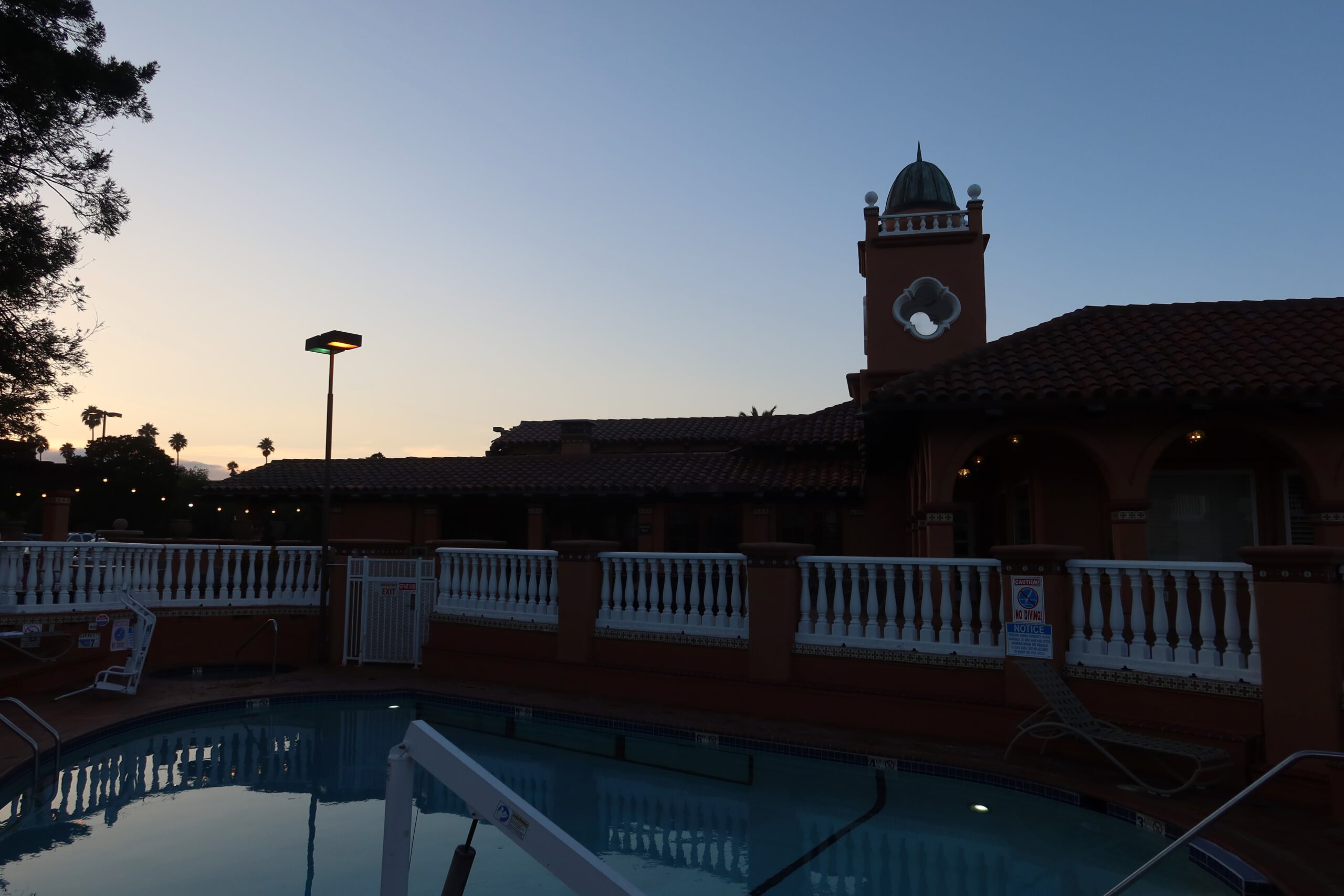 Swimming pool and on-site restaurant area at SFO El Rancho Inn near San Francisco Airport during early evening