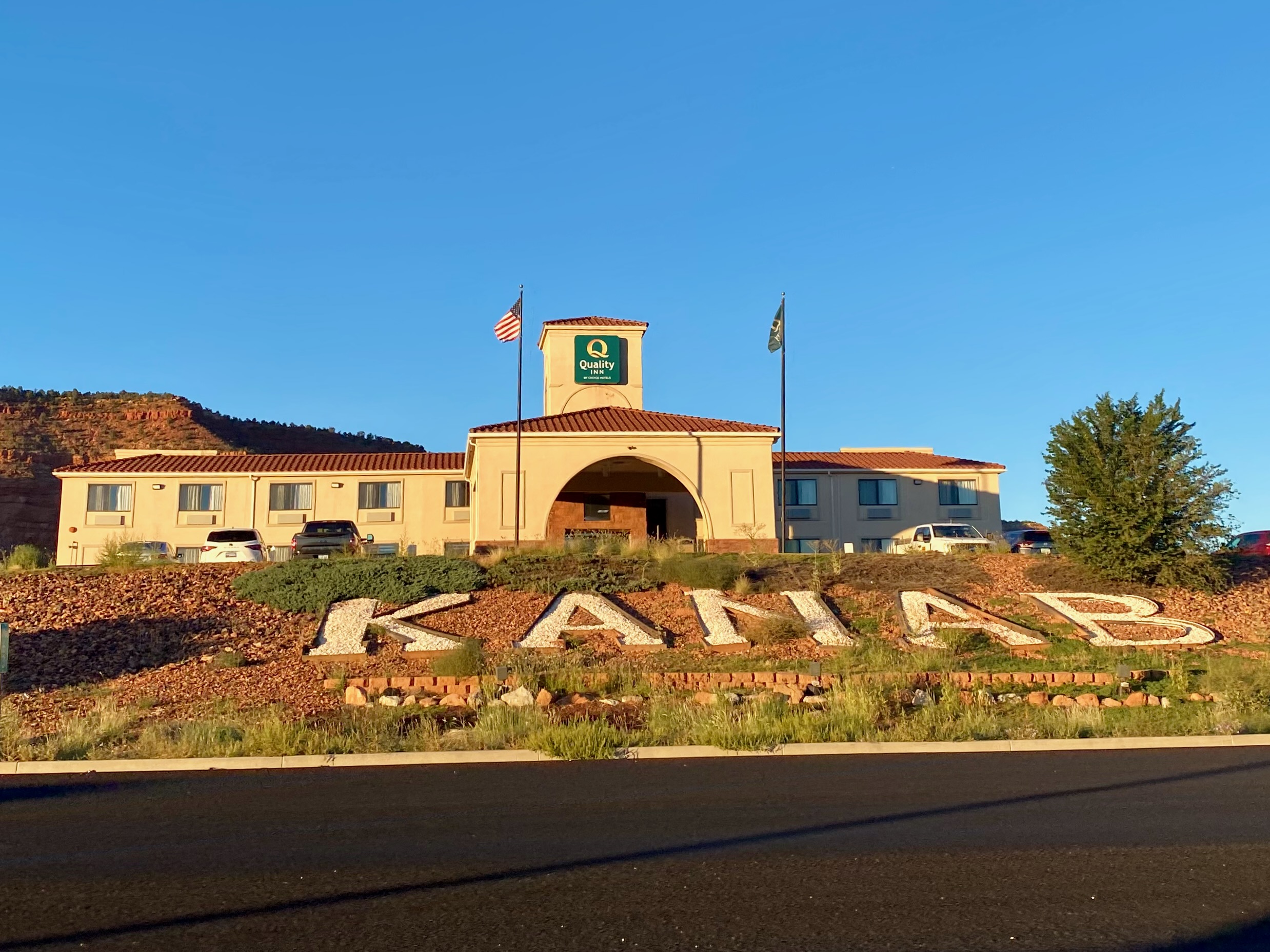 Exterior view of Quality Inn Kanab National Park Area with Kanab hillside sign and red rock surroundings in Kanab, Utah