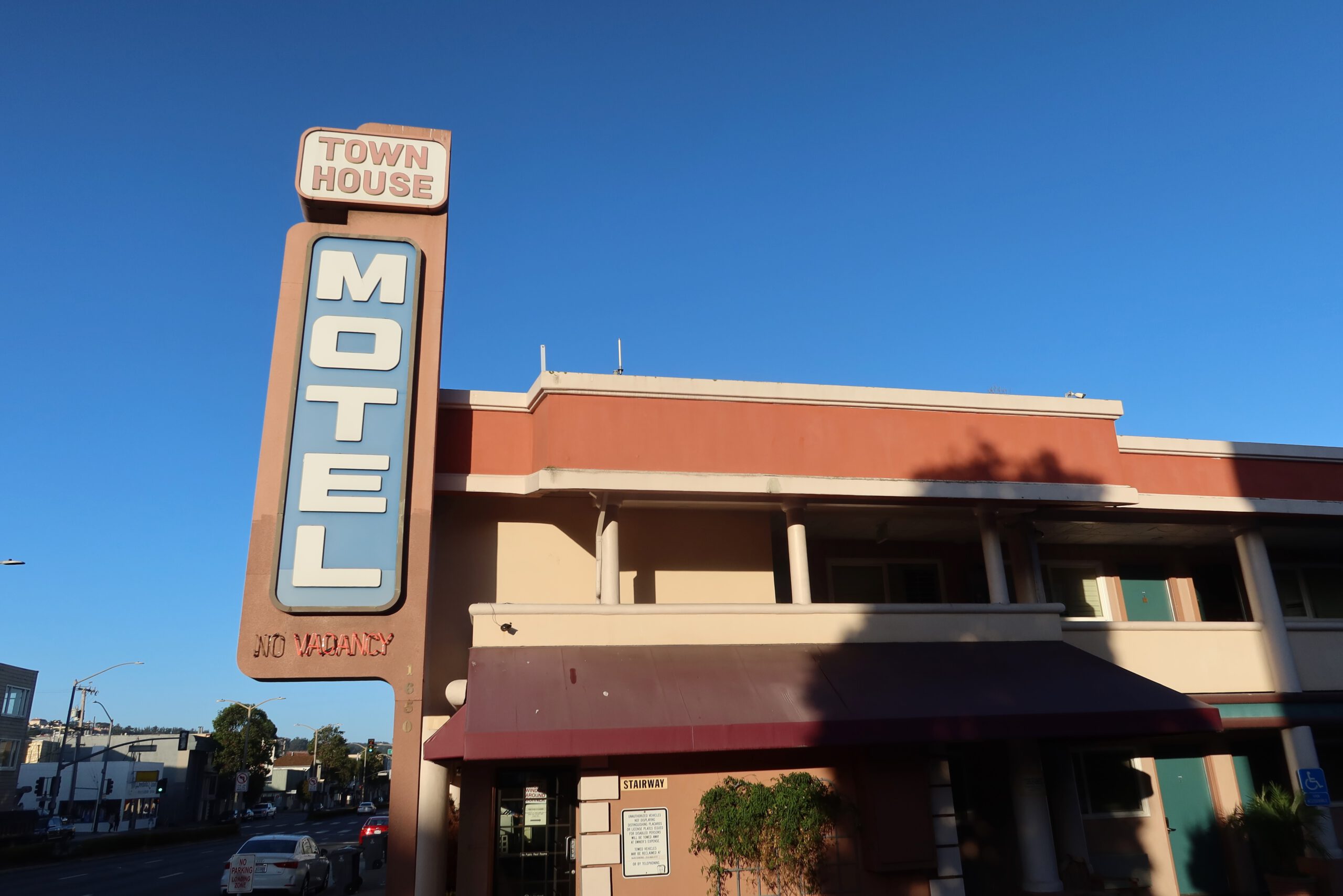 Town House Motel San Francisco exterior on Lombard Street, classic retro motel sign with blue sky, showing the front facade and iconic roadside motel signage in the Marina District