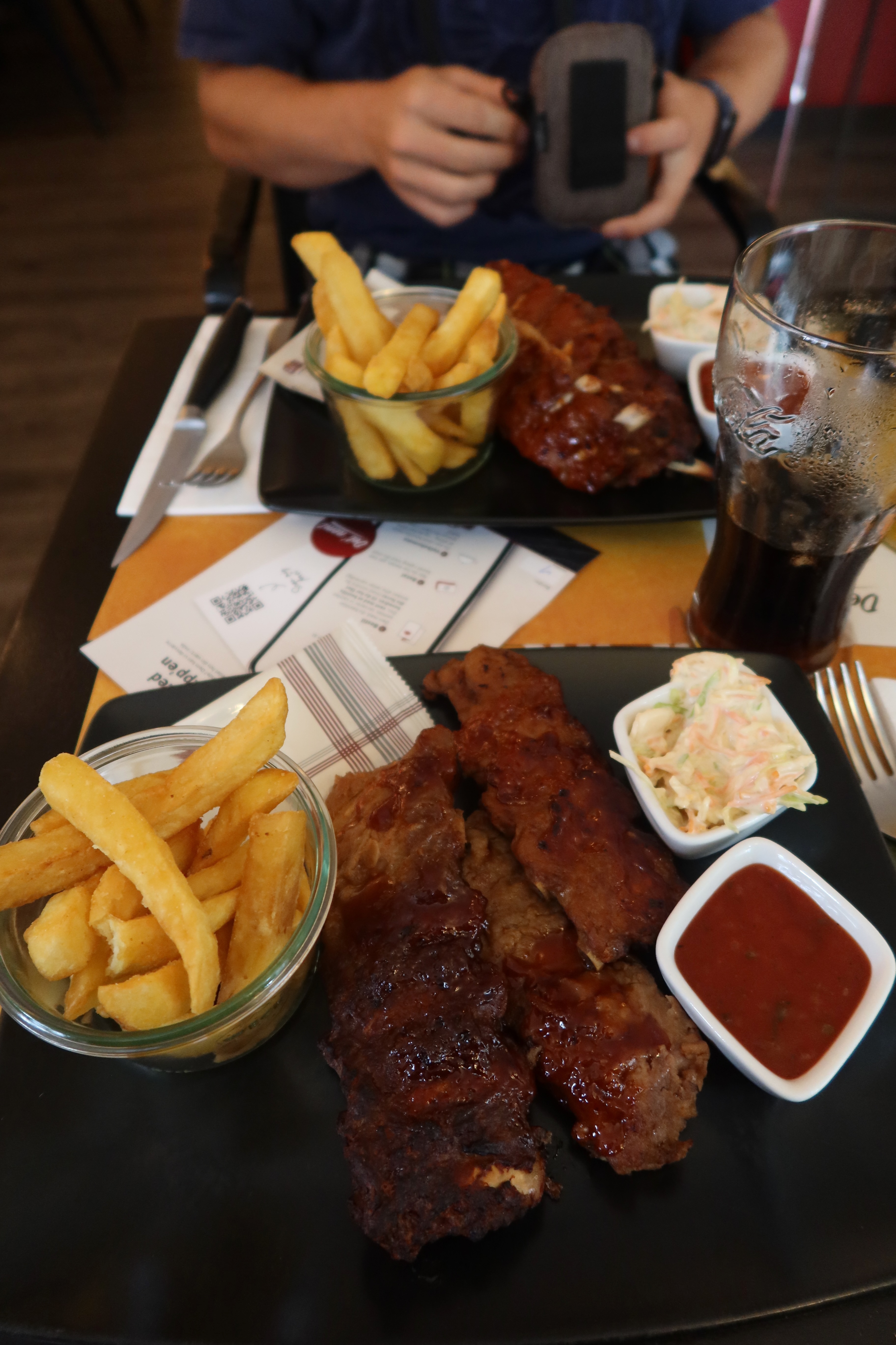 Jensens Bofhus Sonderborg review showing barbecue ribs thick fries coleslaw sauce and large soft drinks during our dinner in Sønderborg Denmark