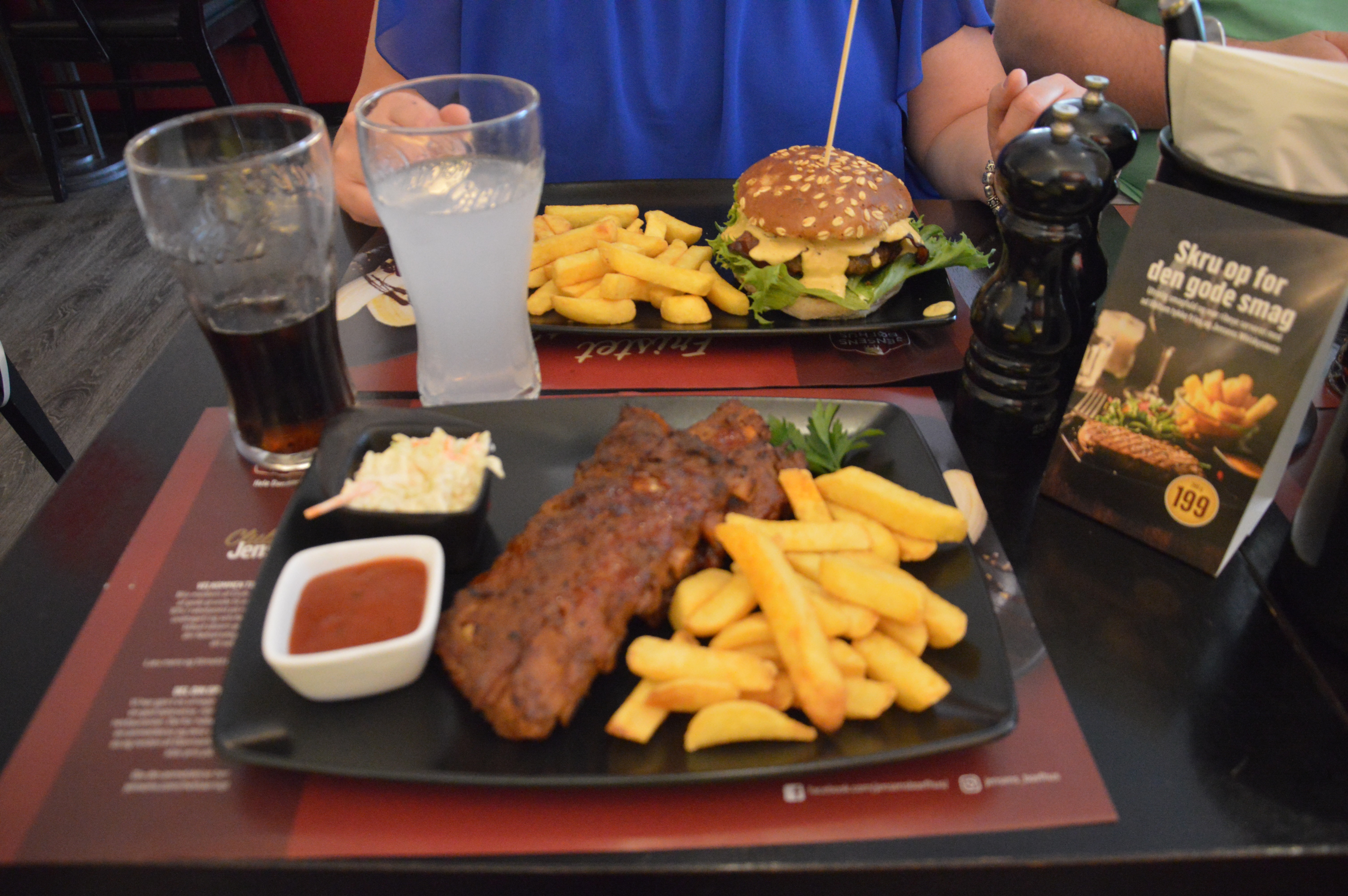 Jensens Bofhus Sonderborg review showing ribs with thick fries coleslaw sauce a burger and large soft drinks inside the former Jensens Bøfhus restaurant