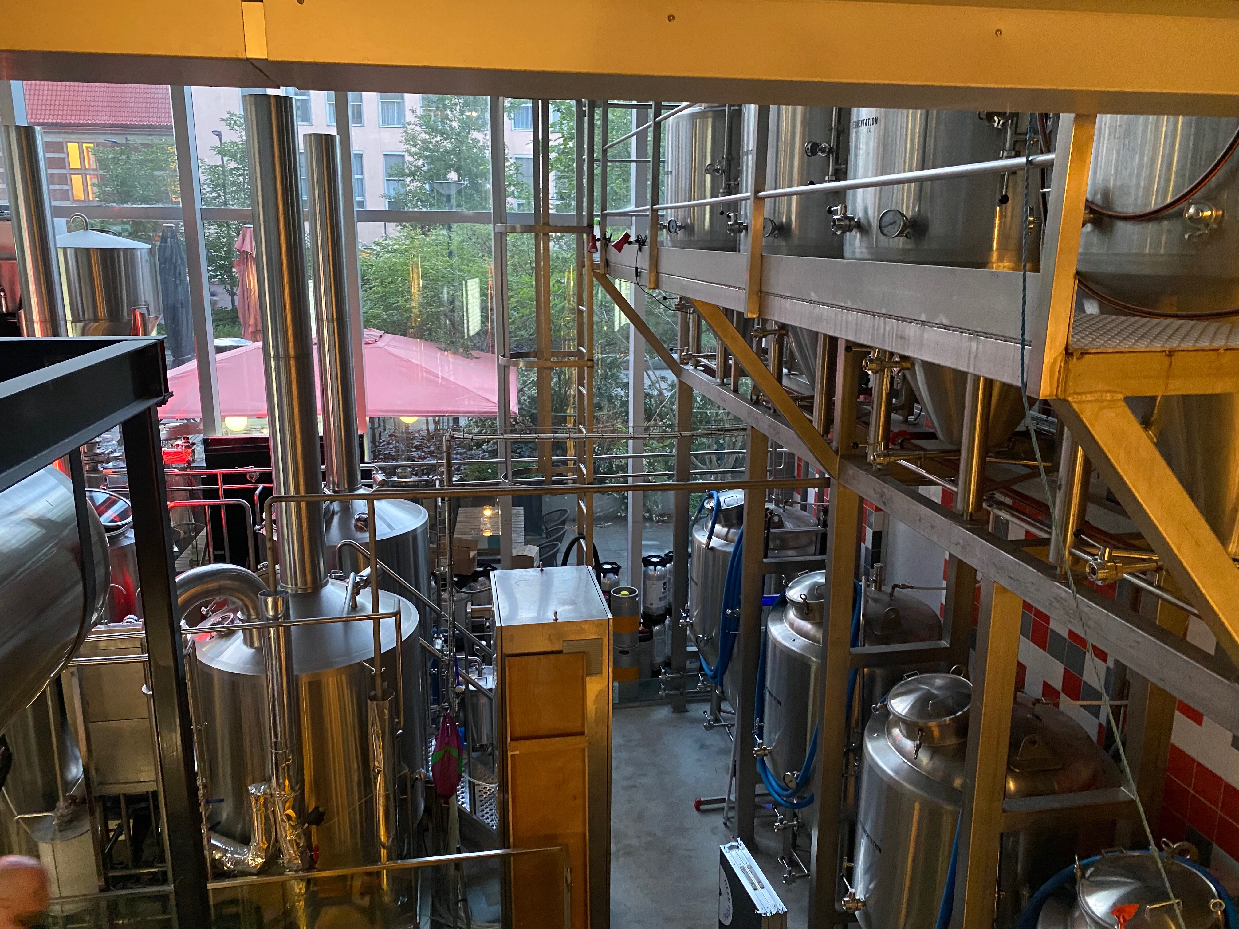 BrewDog Outpost Rotterdam Review with stainless steel brewery tanks pipes brewing equipment and a view toward the terrace at the original Halvemaanpassage location