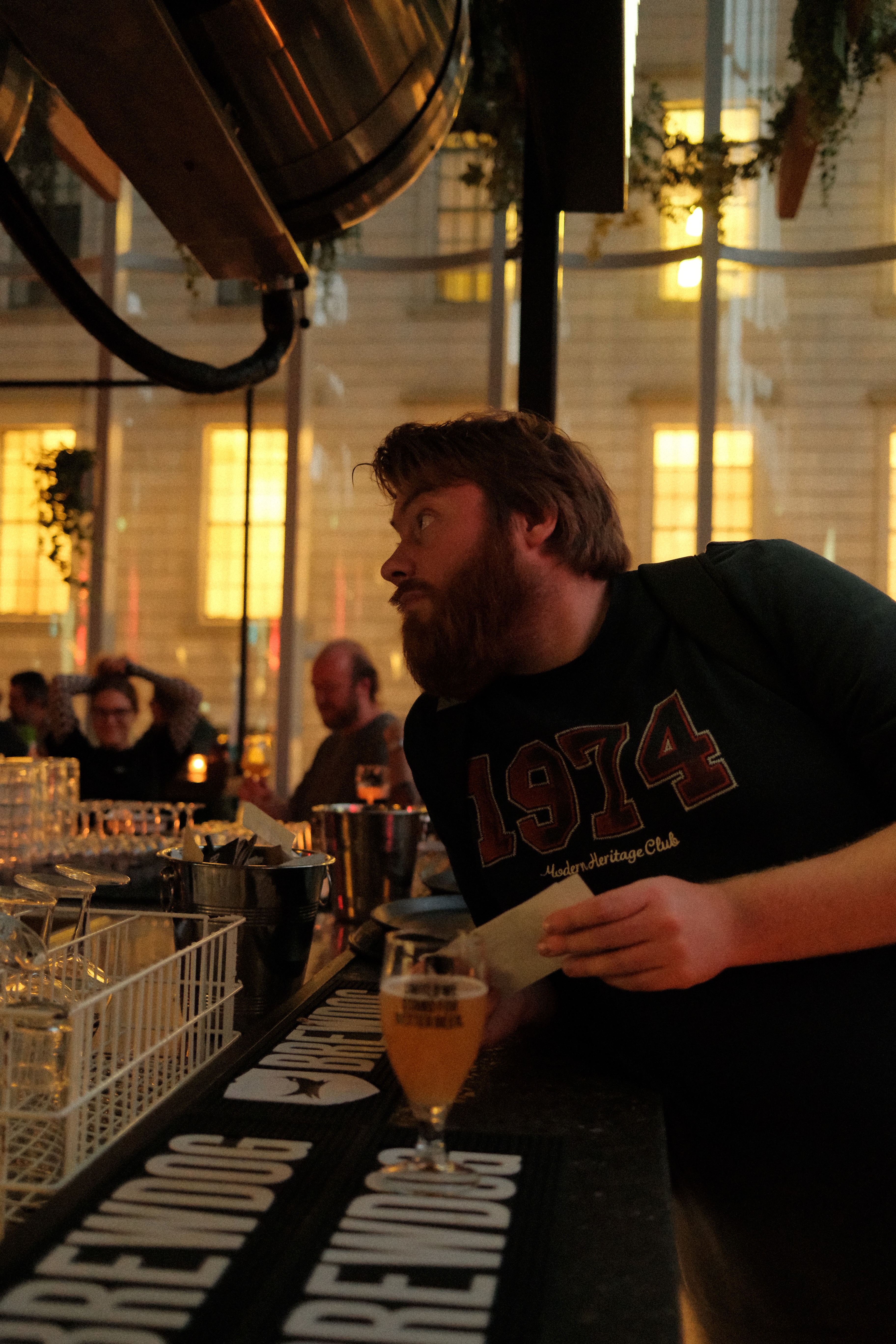 BrewDog Outpost Rotterdam Review with Timo van den Berg at the original Halvemaanpassage bar with BrewDog beer glass warm pub lighting bar counter glassware and craft beer atmosphere