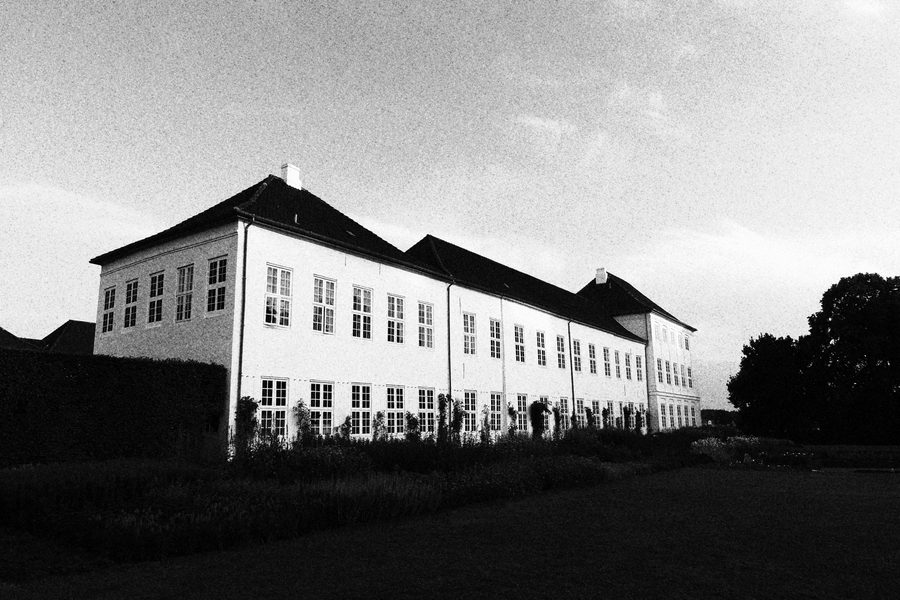 Gråsten Slot in black and white, showing the royal palace facade and garden view in Southern Denmark.