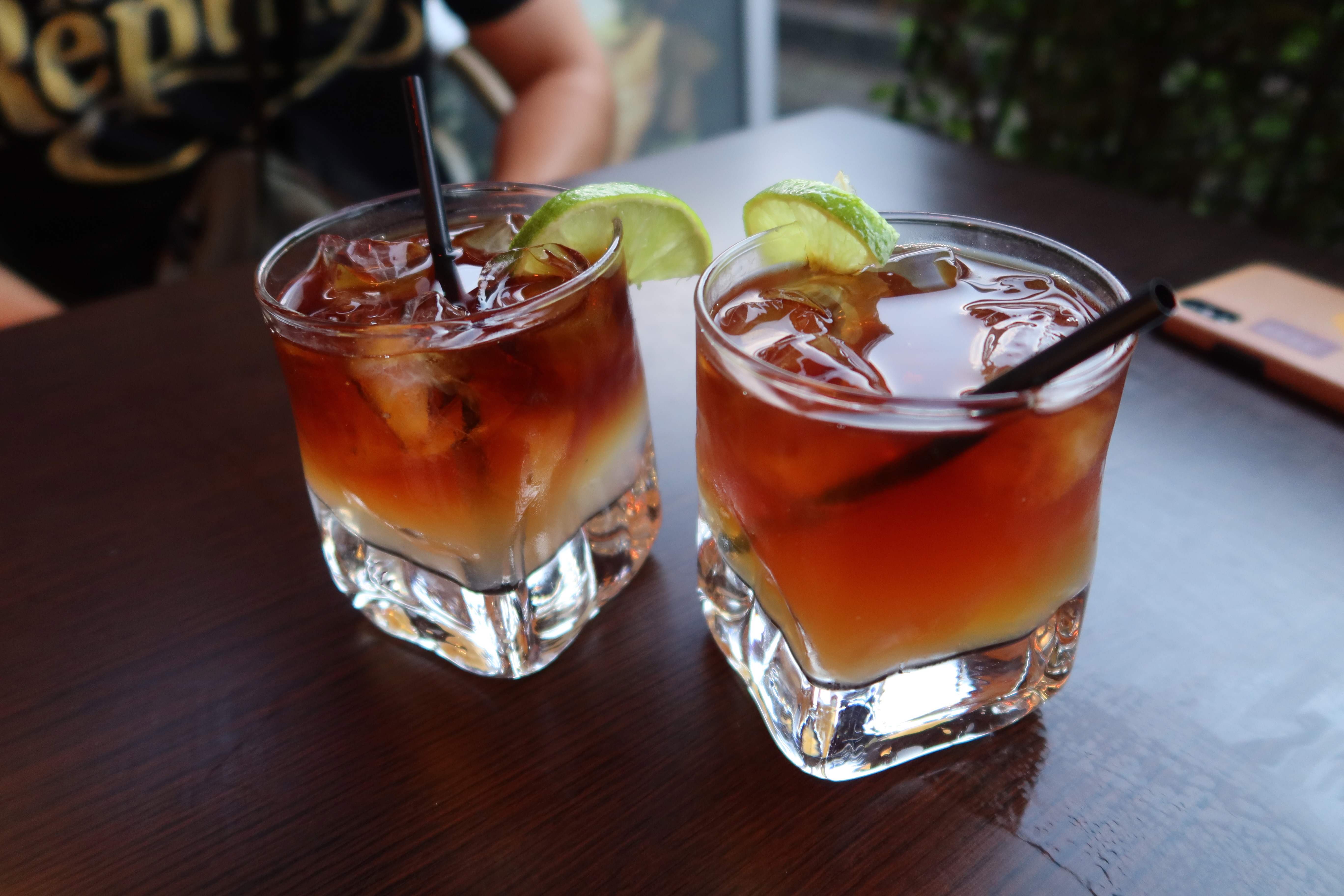 Dronning Louise Esbjerg Review with two Dark n Stormy drinks on a wooden terrace table in Esbjerg Denmark