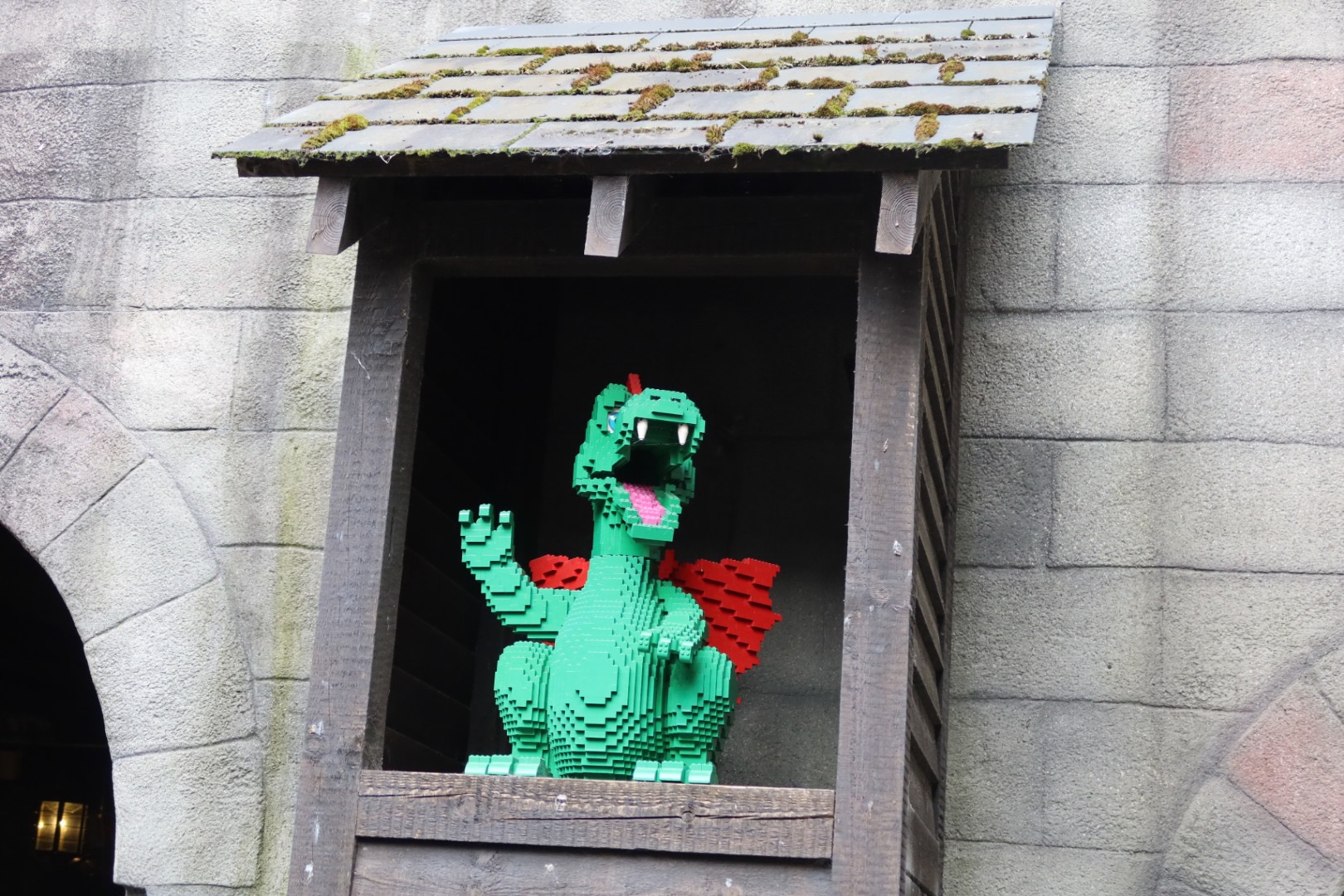 LEGOLAND Billund review IMG 2766 showing a green LEGO dragon in a castle window near The Dragon ride at LEGOLAND Billund Denmark