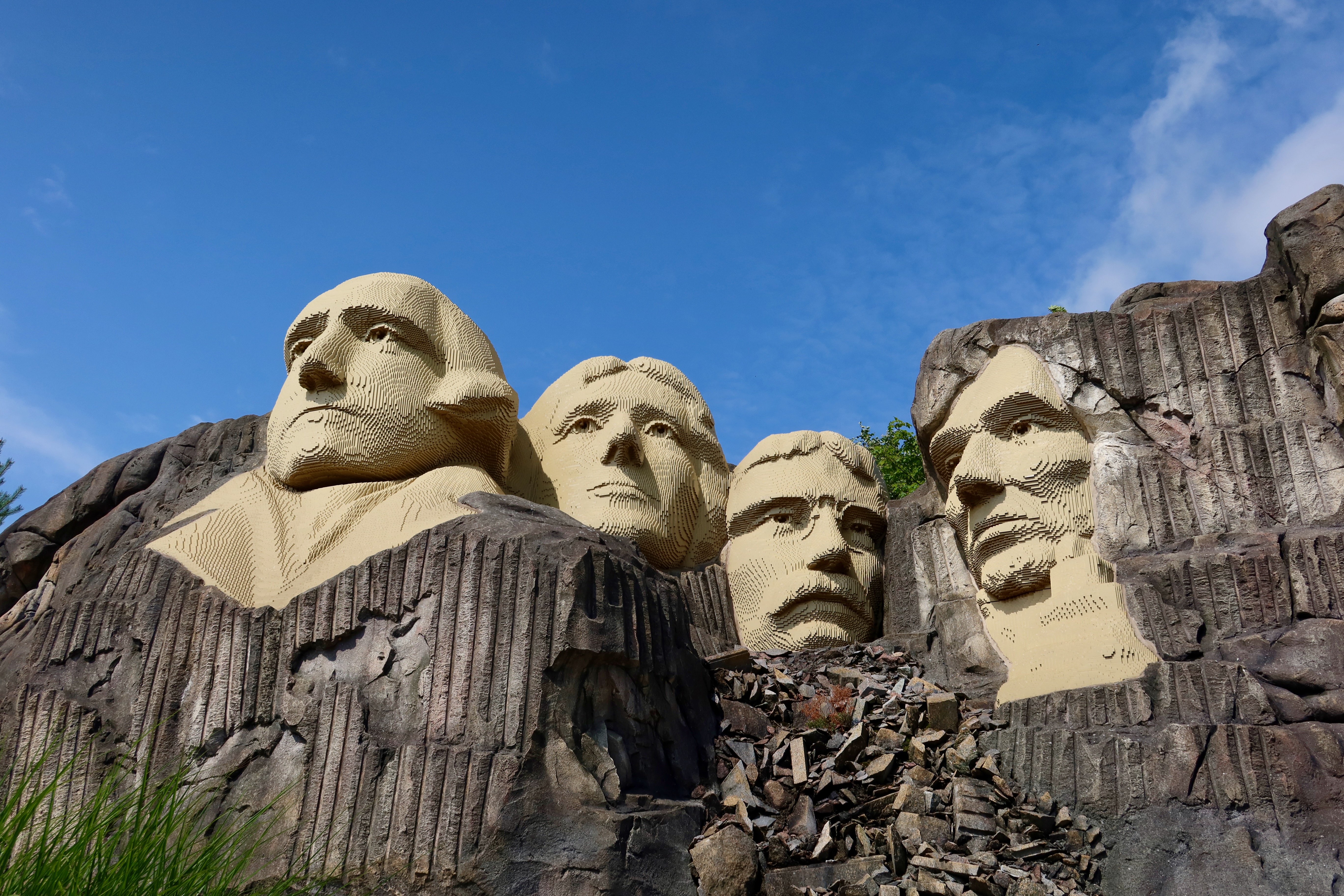 LEGOLAND Billund review IMG 2797 showing the LEGO Mount Rushmore style monument with large brick built faces rocks and blue sky at LEGOLAND Billund Denmark