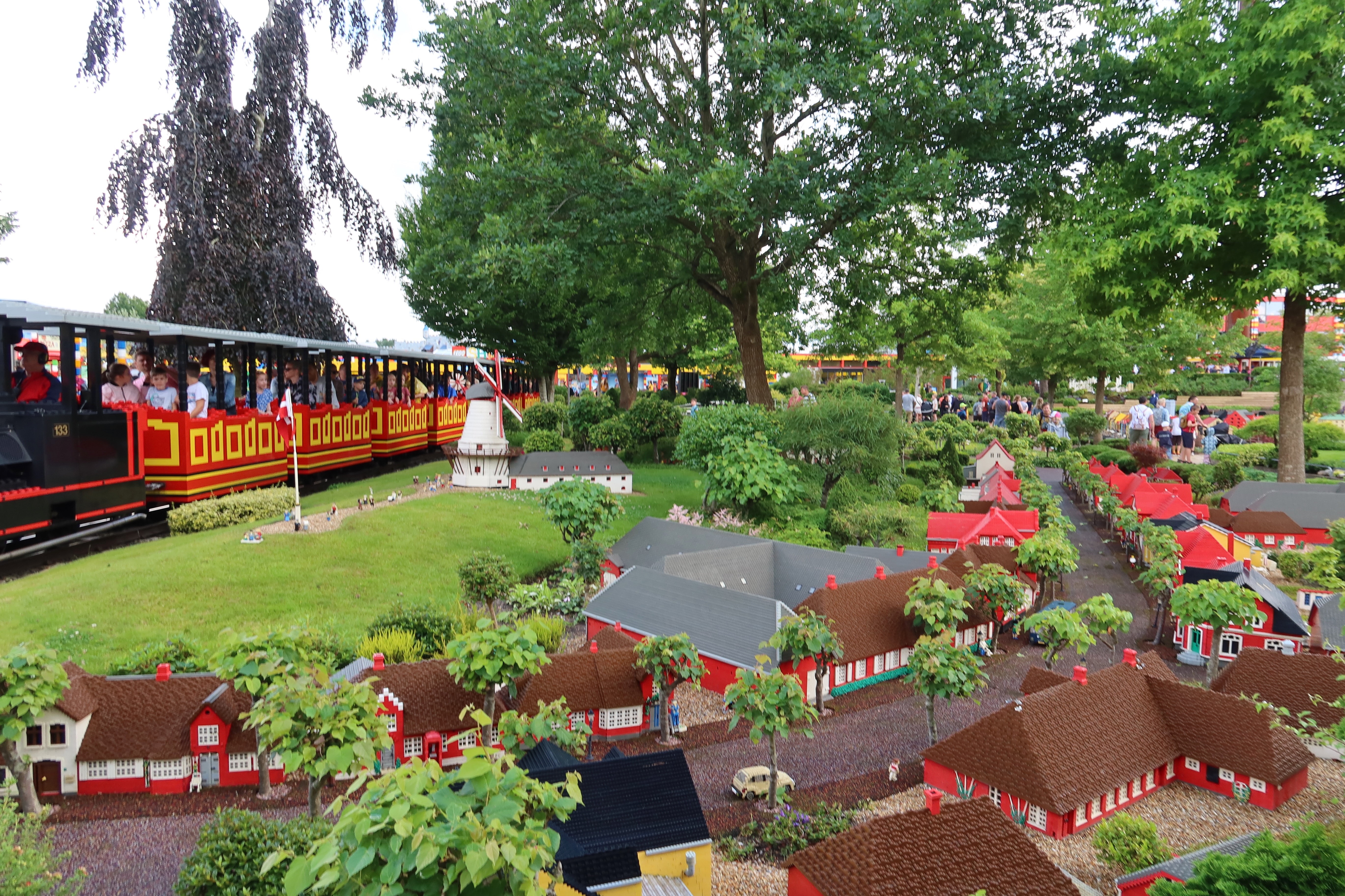 LEGOLAND Billund review IMG 2834 showing the LEGOLAND train passing through Miniland with LEGO village buildings trees and miniature Danish scenery in Billund Denmark