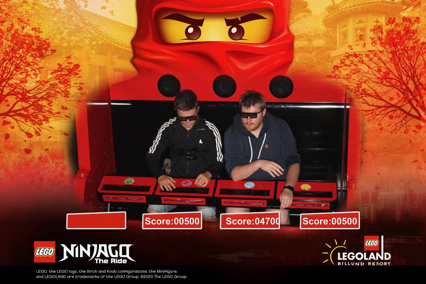 LEGOLAND Billund review IMG 8445 showing two visitors wearing 3D glasses on NINJAGO The Ride with LEGO scores and a large red ninja figure at LEGOLAND Billund Denmark