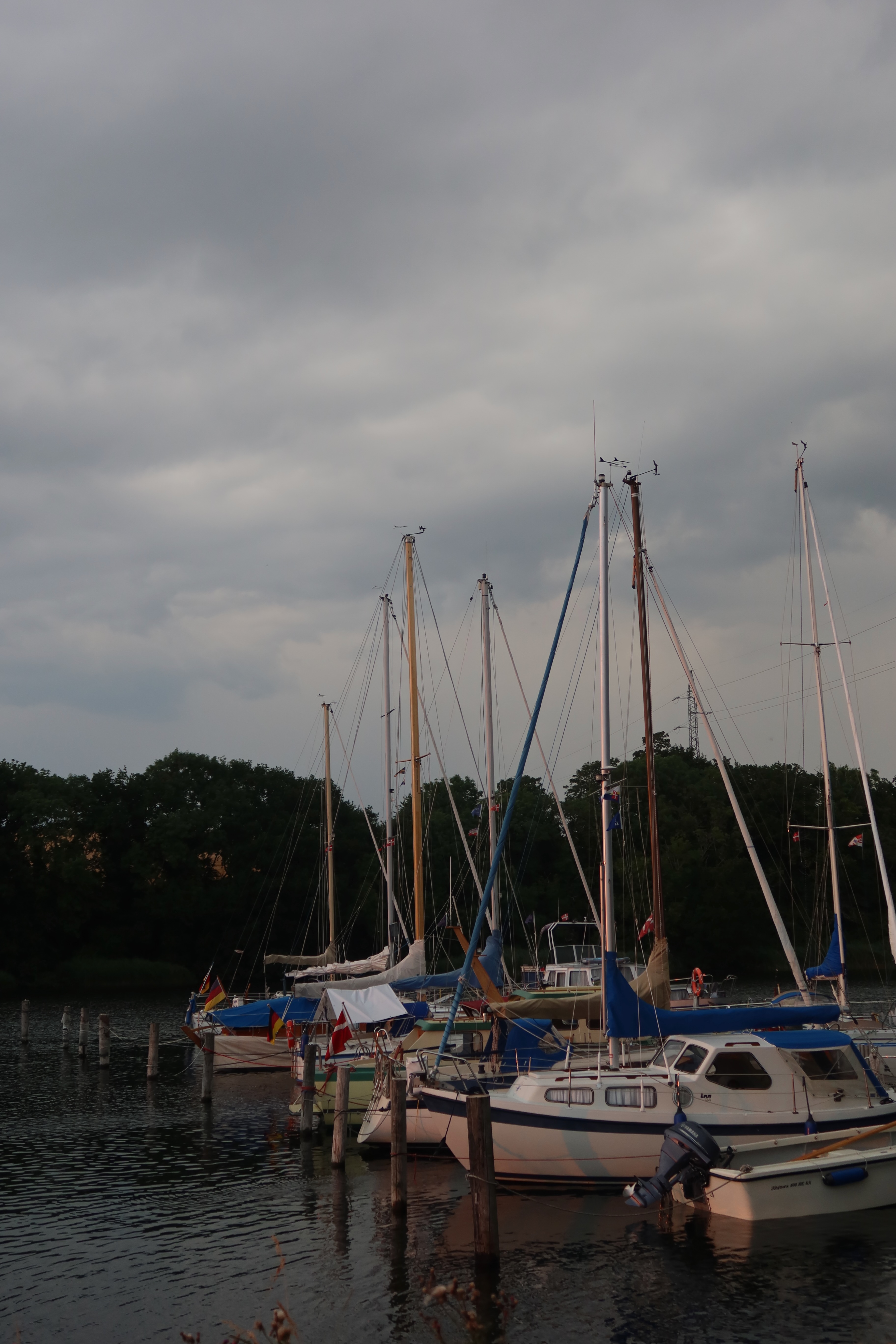 Mjelsvig Harbor with sailboats under a dramatic stormy sky in Mjels Denmark