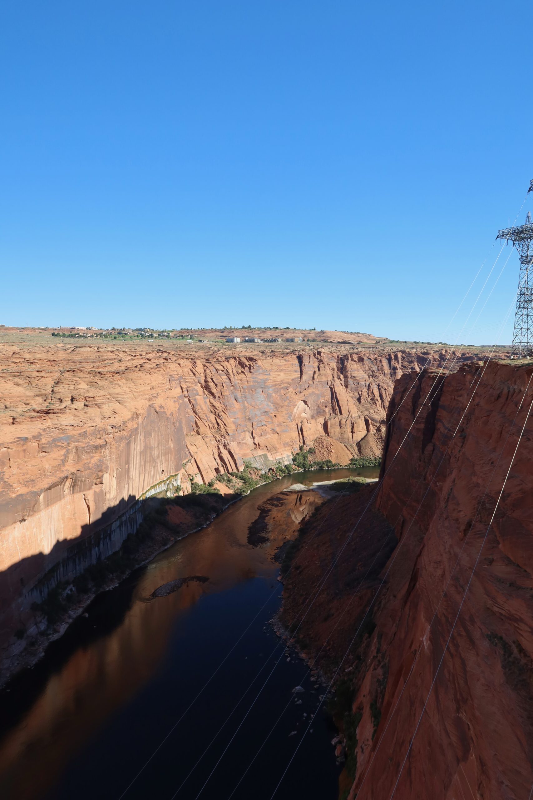 Colorado River flowing through Glen Canyon below Glen Canyon Dam, deep red rock canyon walls and dramatic desert landscape near Page, Arizona