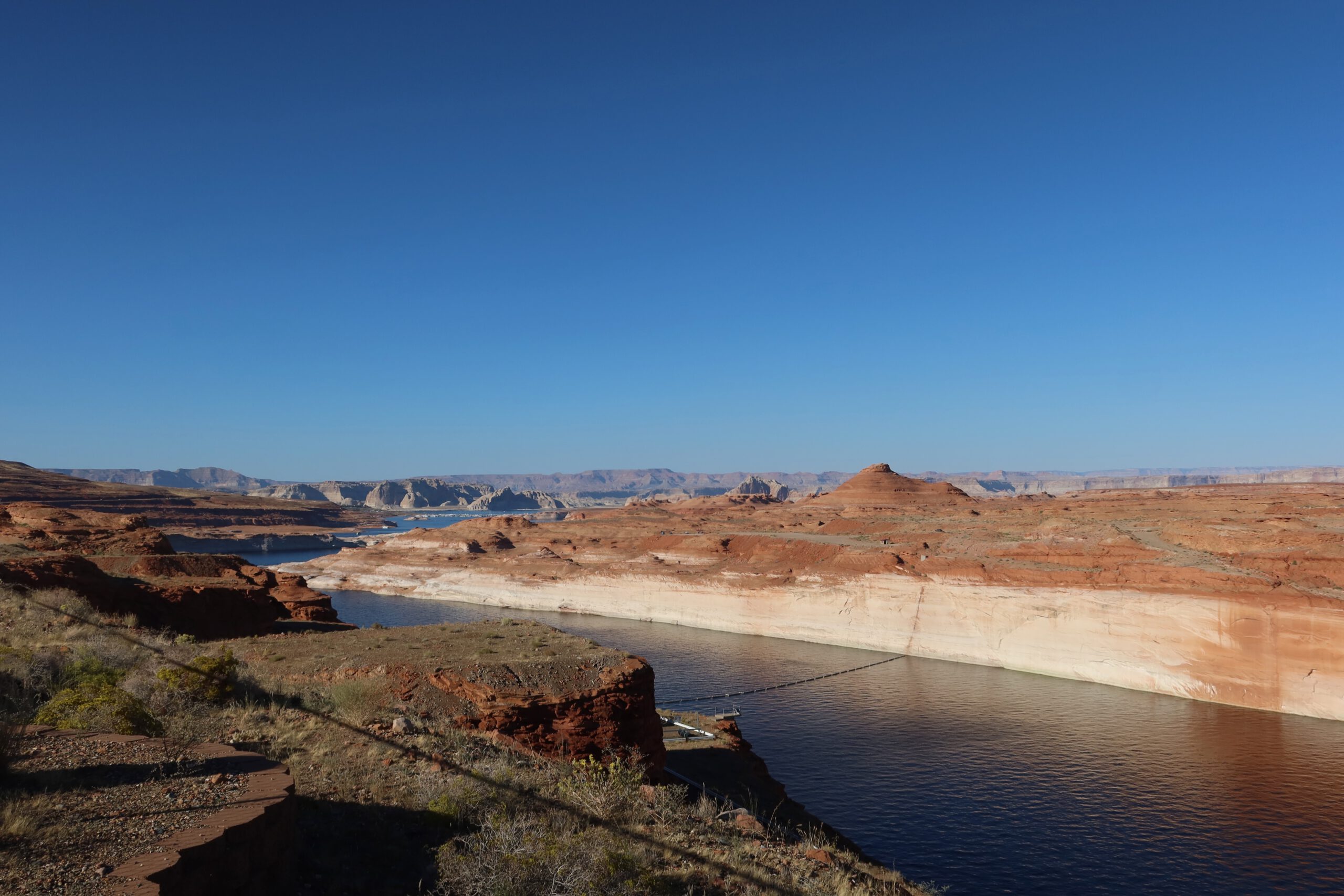 Glen Canyon landscape with the Colorado River flowing through red rock cliffs and desert terrain, calm water and wide open views near Page, Arizona