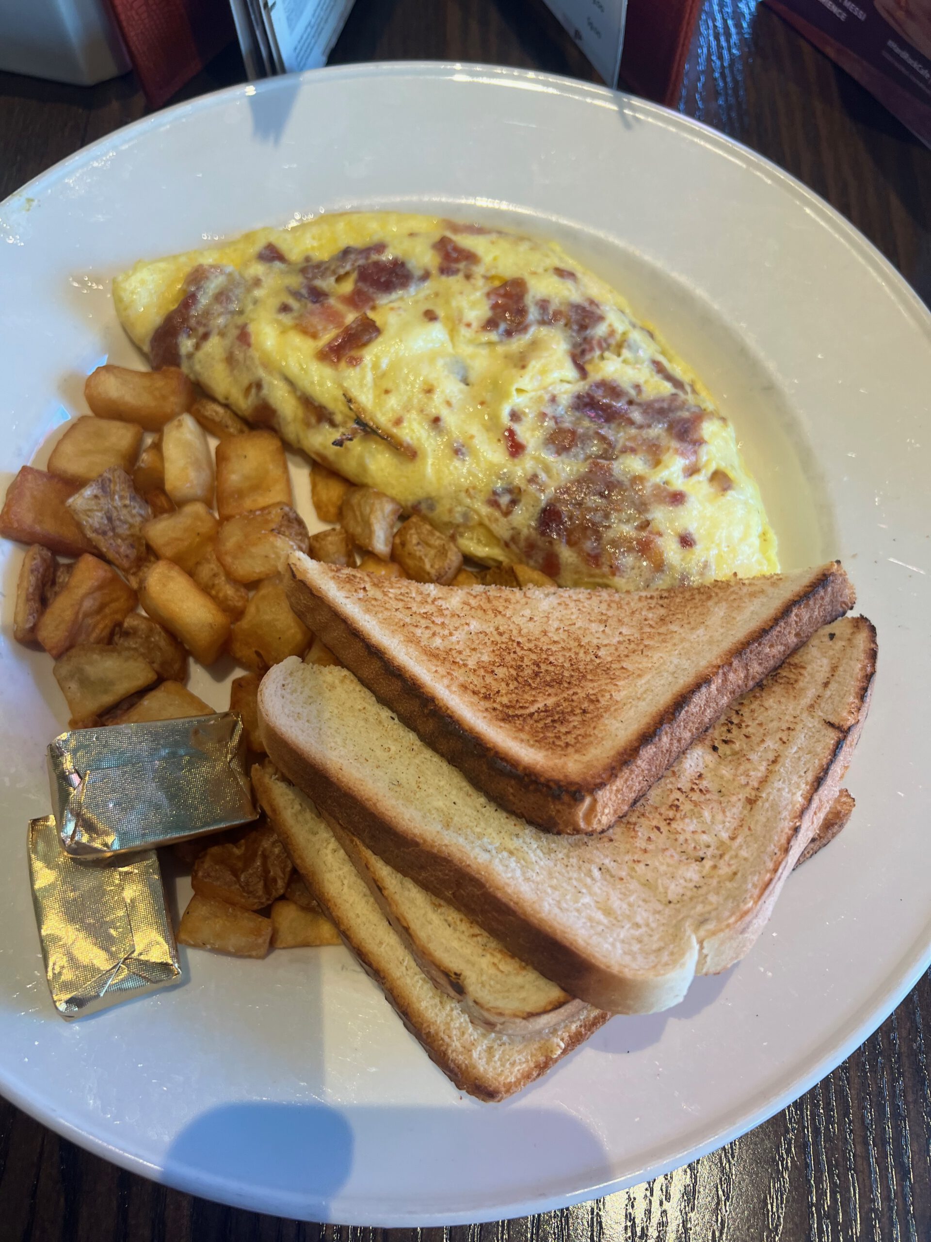 Classic American omelet breakfast with crispy breakfast potatoes and toasted bread at Hard Rock Cafe Las Vegas Strip.