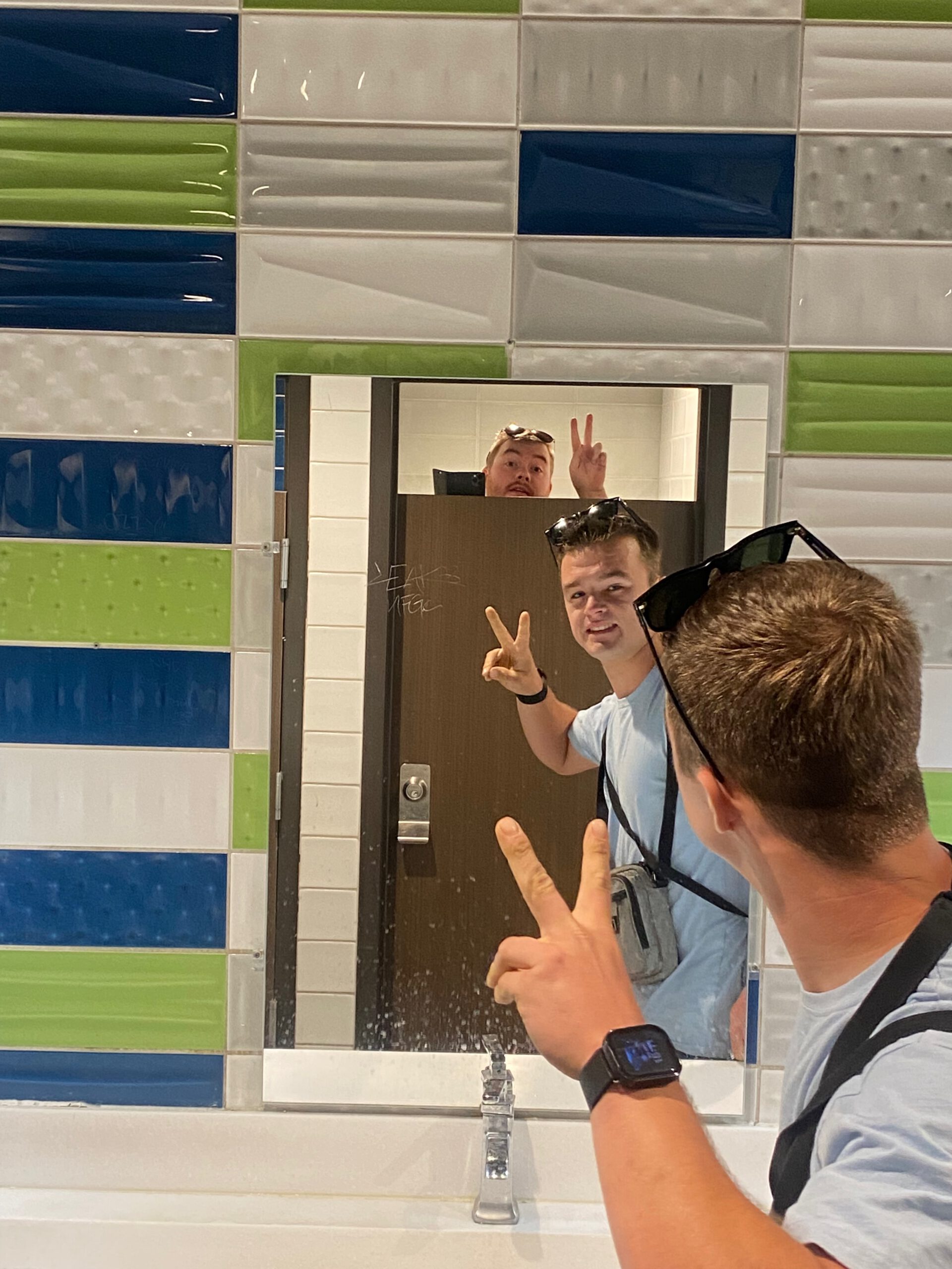 Mirror view inside the restroom at McDonalds Primm Nevada showing colorful tiled walls and a quiet, empty interior during the afternoon