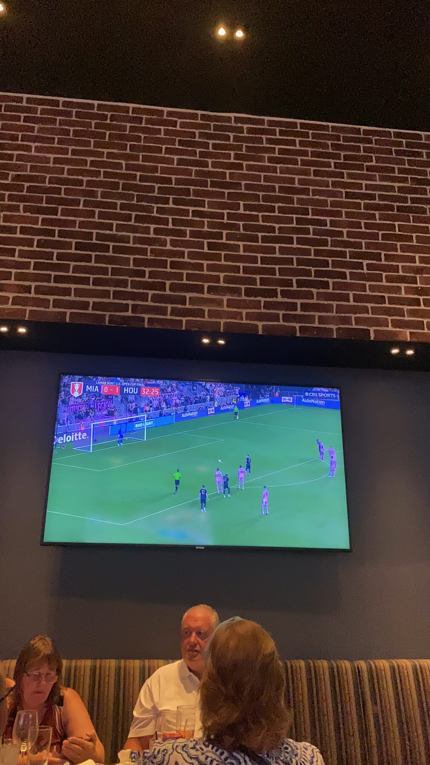 Interior view of Public House sports bar at Luxor Hotel & Casino Las Vegas, showing guests seated below a large TV screen broadcasting a live soccer match on CBS Sports.
