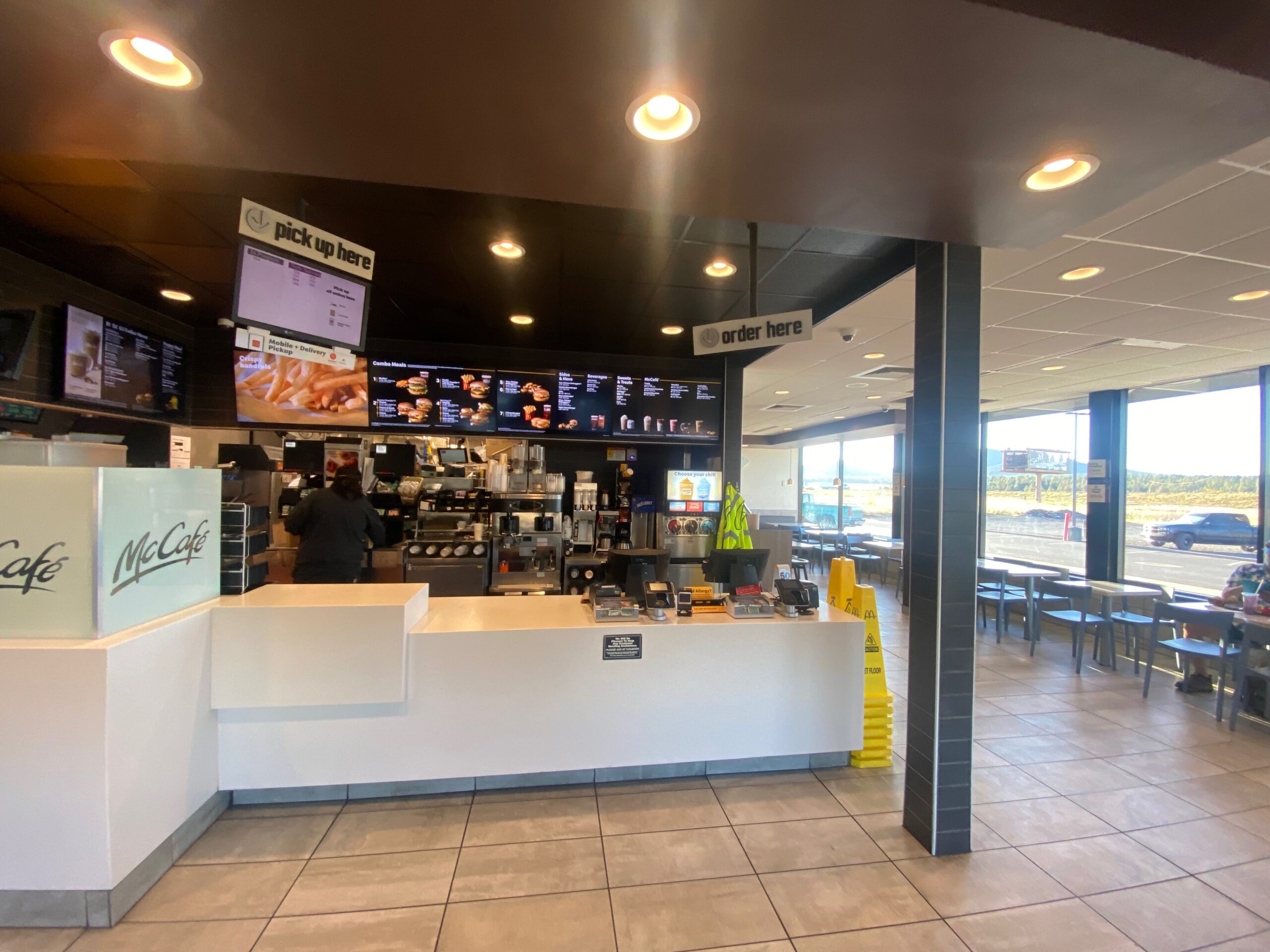 Modern interior of McDonalds in Williams Arizona with seating area large windows and highway scenery visible outside