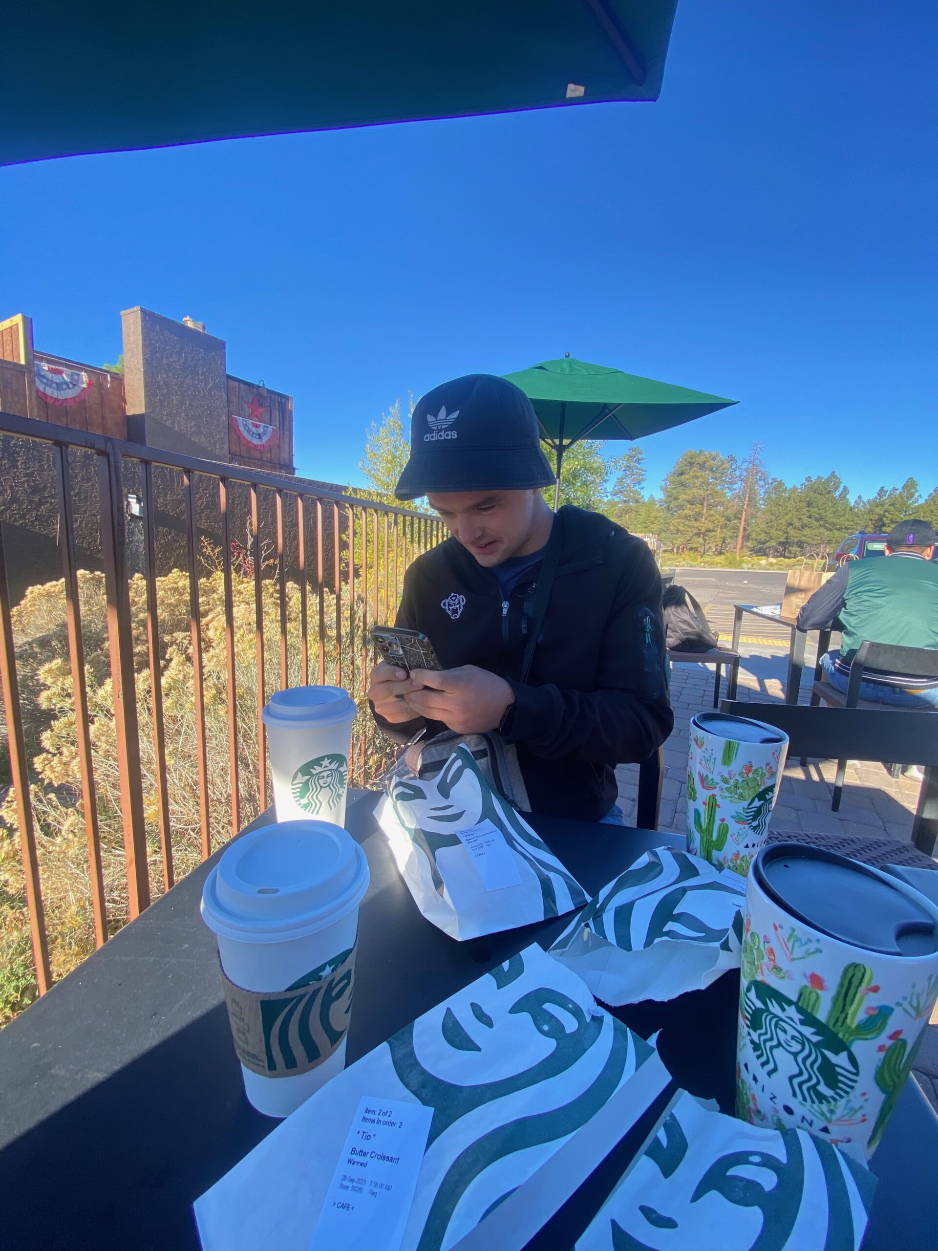 Enjoying coffee and breakfast at the outdoor terrace of Starbucks near the Grand Canyon in Tusayan, Arizona, on a sunny morning.