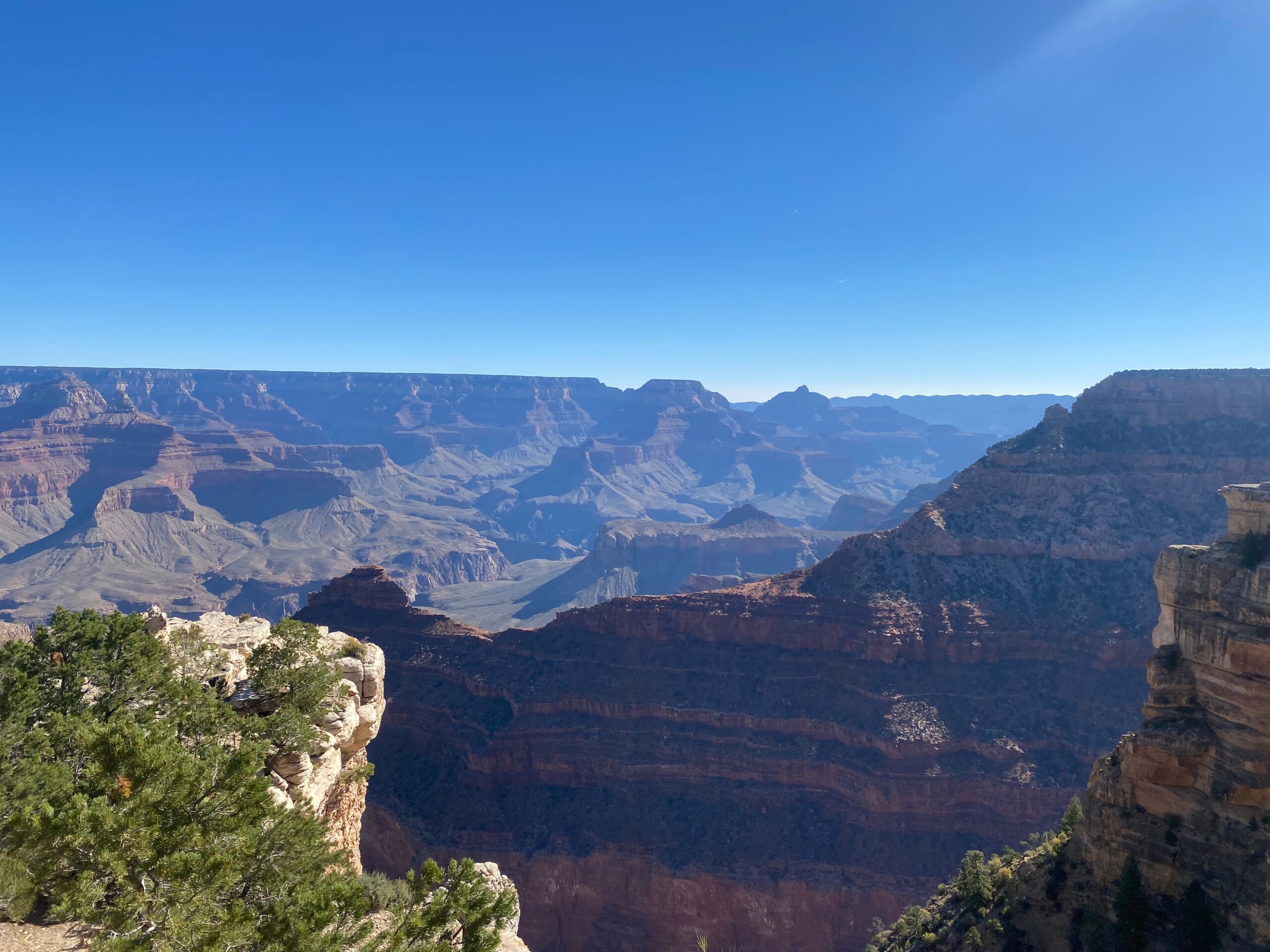 Scenic overlook at Grand Canyon National Park featuring rugged canyon walls, layered cliffs, and expansive desert scenery