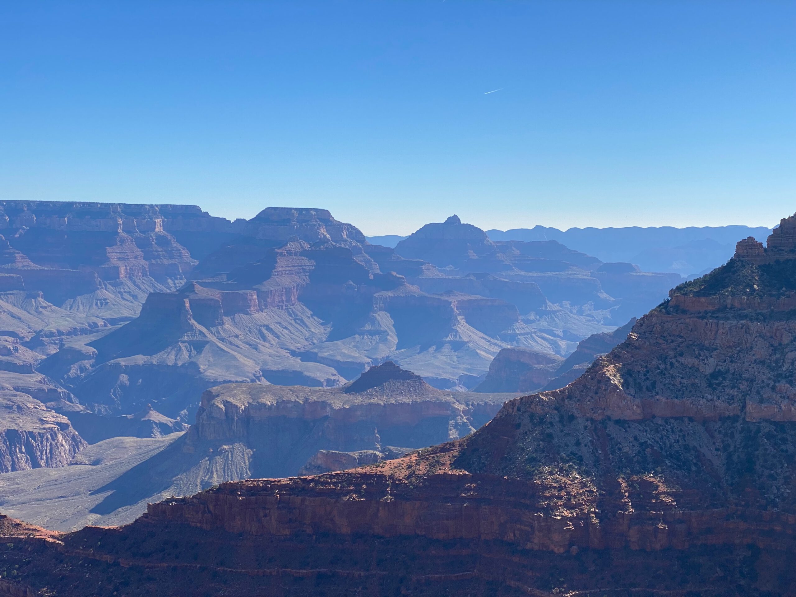 Distant canyon ridges and mesas inside Grand Canyon National Park creating a dramatic sense of scale and natural depth