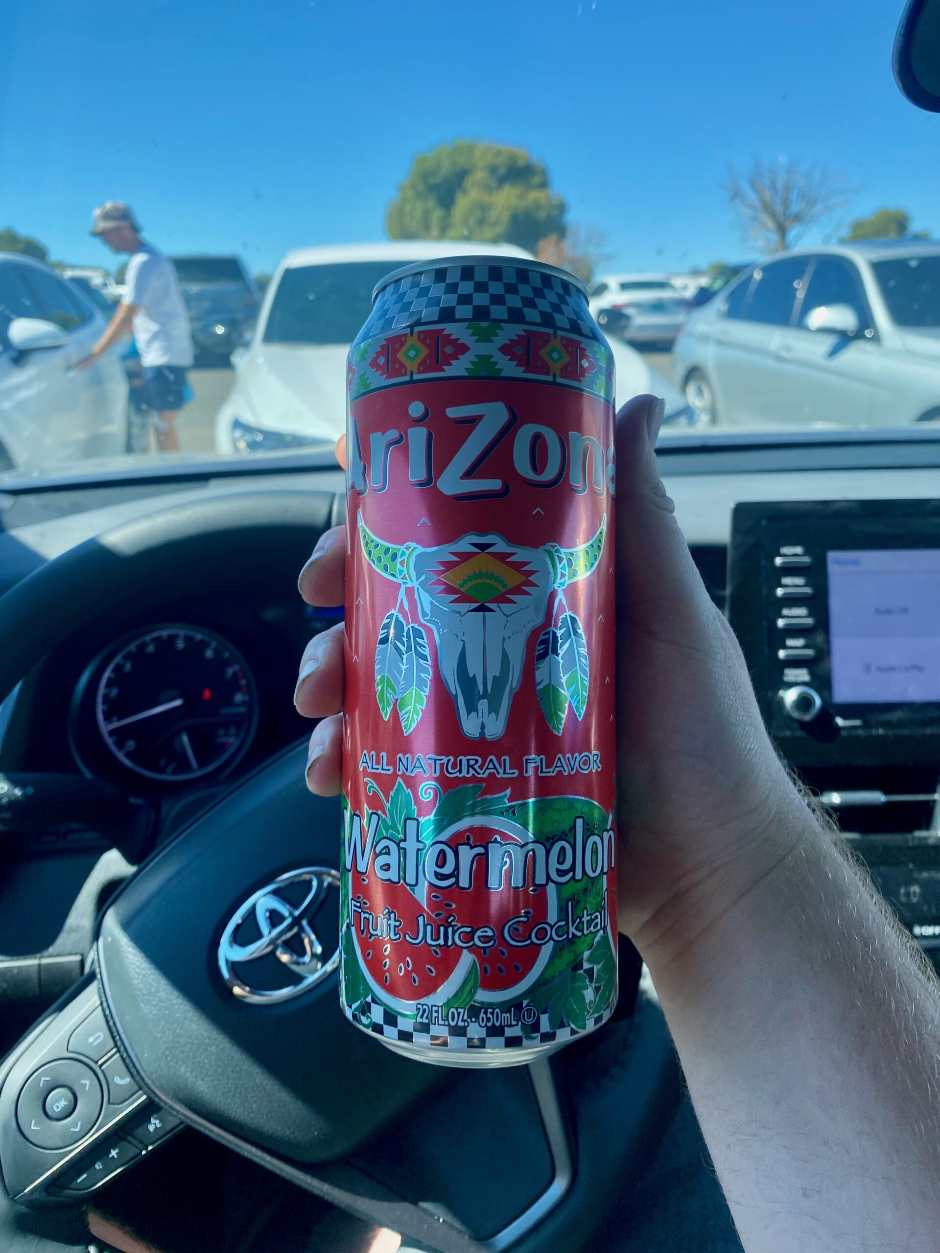 Arizona Watermelon fruit juice can held inside a car during a road trip near Grand Canyon National Park on a sunny day