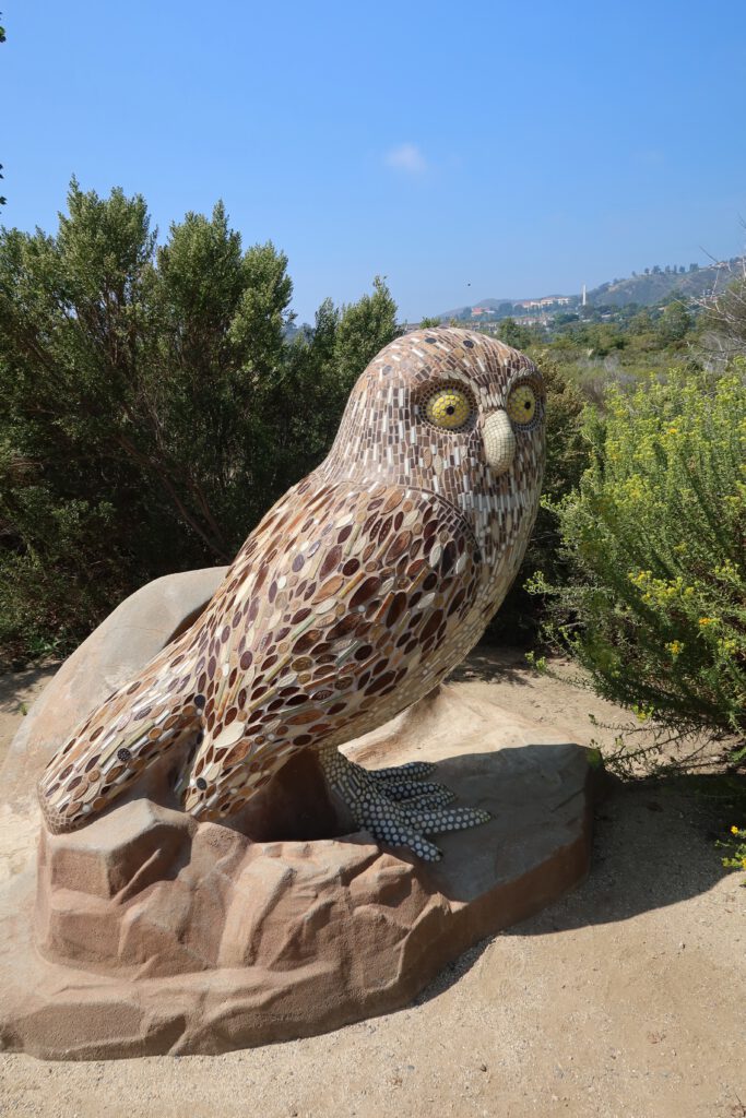 Mosaic owl sculpture at Legacy Park in Malibu, California surrounded by native plants and hills