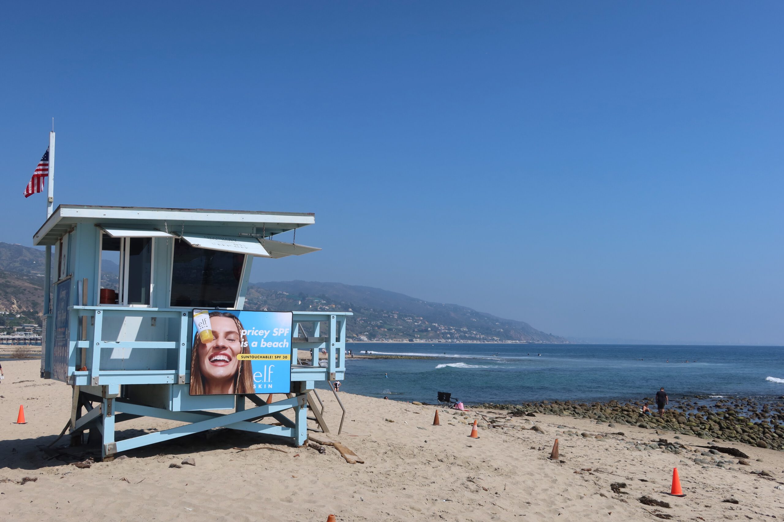 Lifeguard tower at Malibu Lagoon State Beach with Pacific Ocean and clear blue sky in Malibu, California