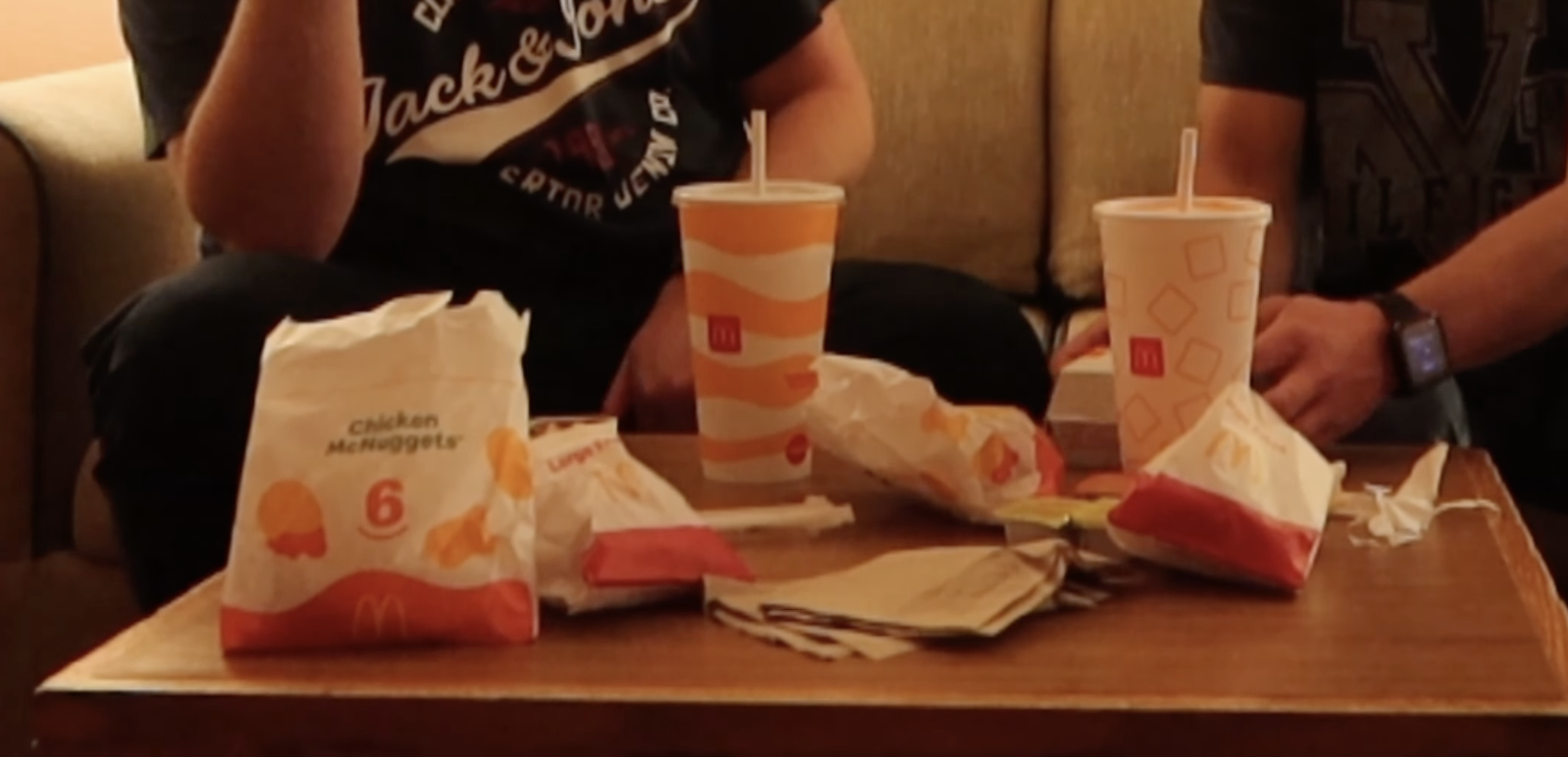 McDonalds Millbrae El Camino Real food spread with Chicken McNuggets, burgers, fries, and soft drinks on a table inside the hotel room