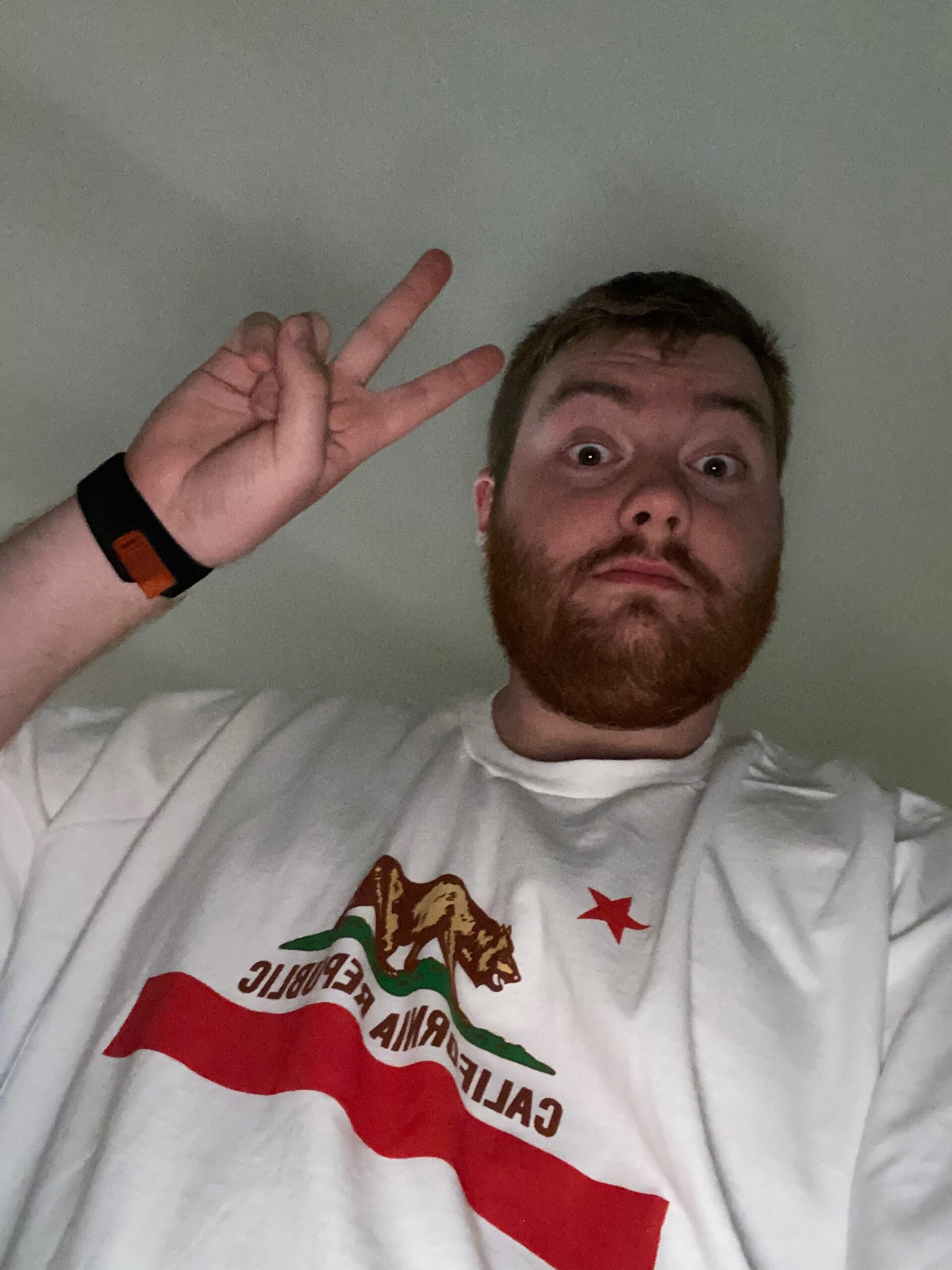 Visitor "Timo van den Berg" wearing a white California Republic T shirt with the bear and red star emblem, posing indoors after visiting the California State Capitol Museum.