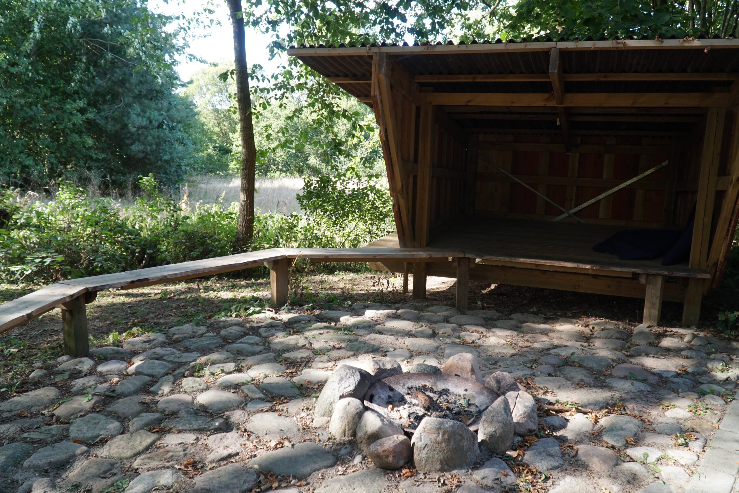 Solevad Cottage in the Forest, wooden outdoor shelter with fire pit and forest surroundings, quiet nature stay near Odense, Denmark