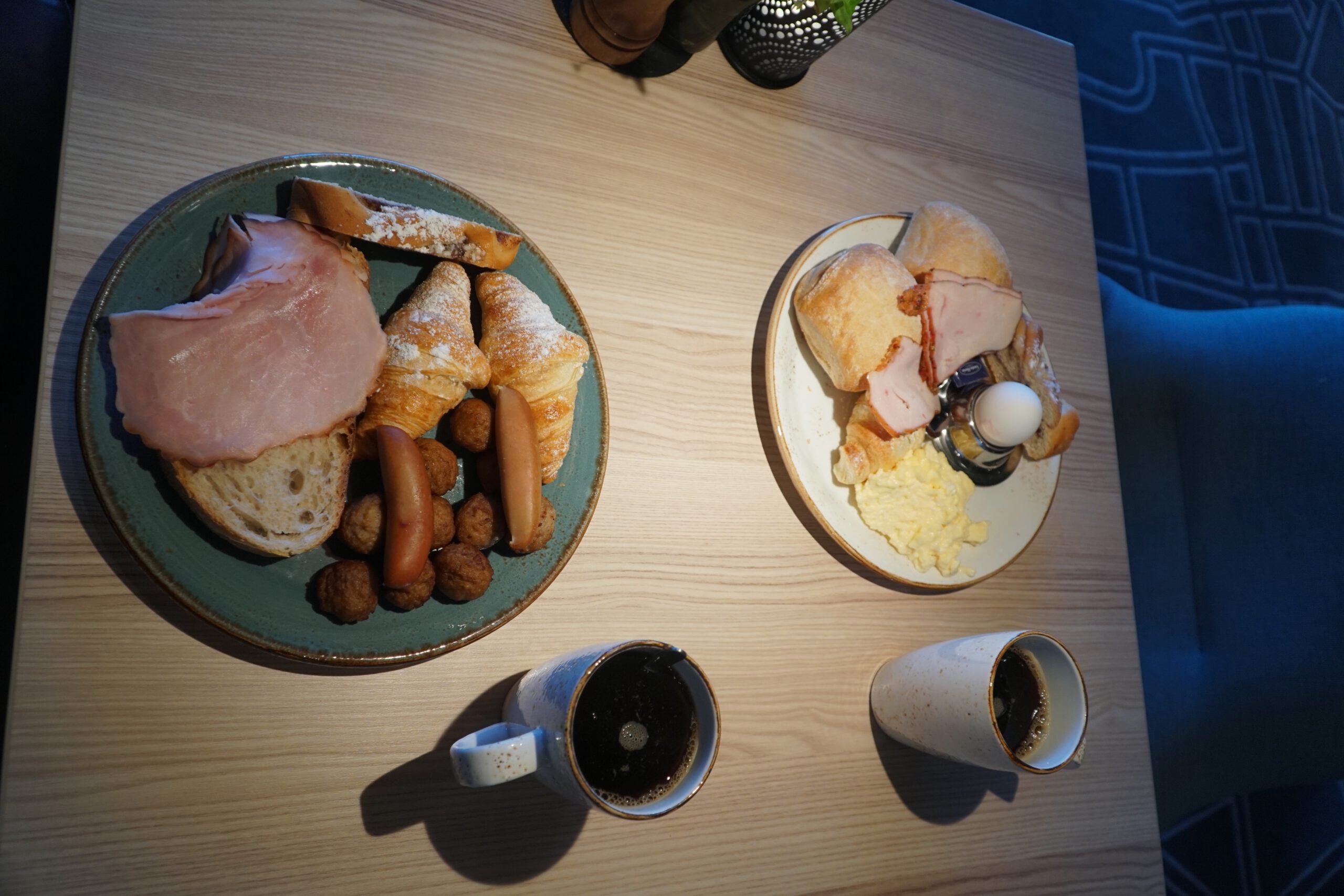 Scandic Luleå Hotel breakfast table with Scandinavian buffet items, fresh bread, pastries, sausages, eggs and coffee in Luleå Sweden