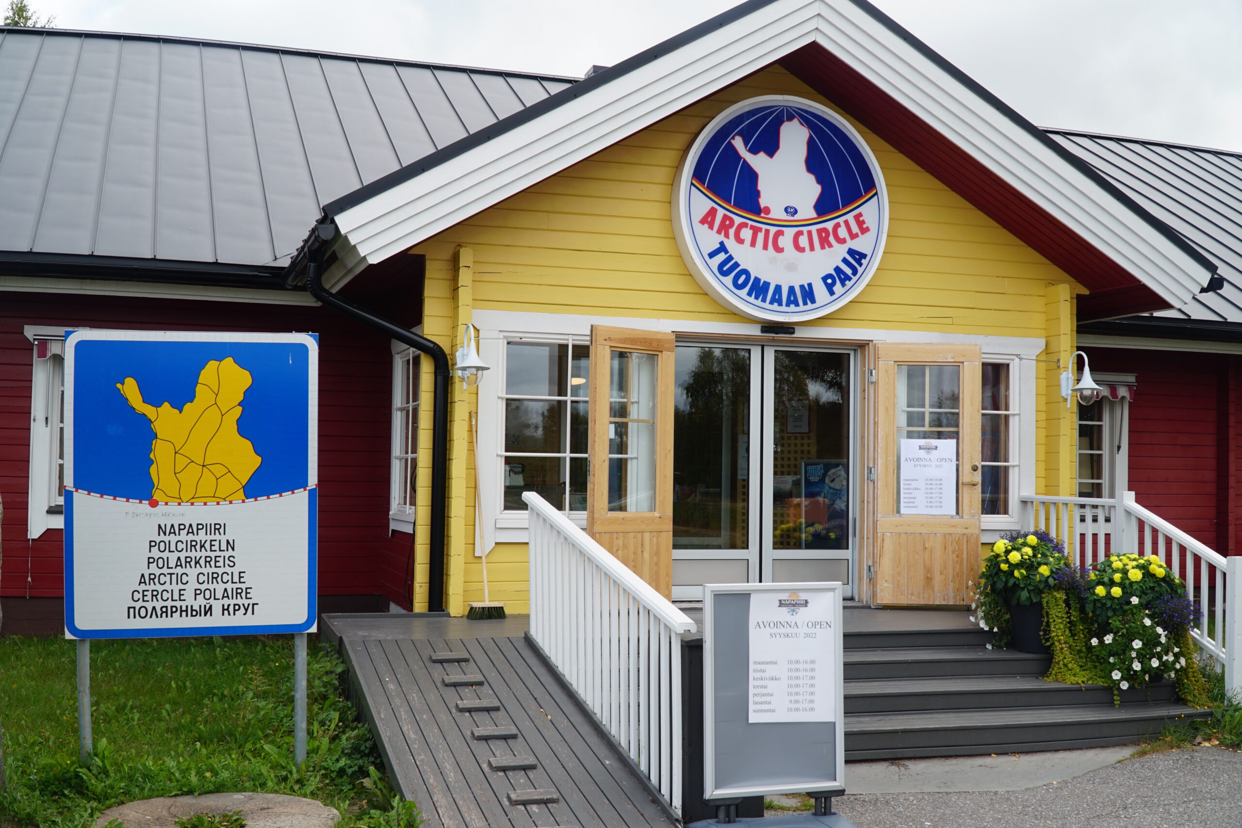 Arctic Circle Tuomaan Tupa Finland, iconic entrance of the Arctic Circle visitor center in Juoksenki, Lapland, featuring the official Napapiiri sign, wooden facade, and welcoming road trip stop along the E8 highway