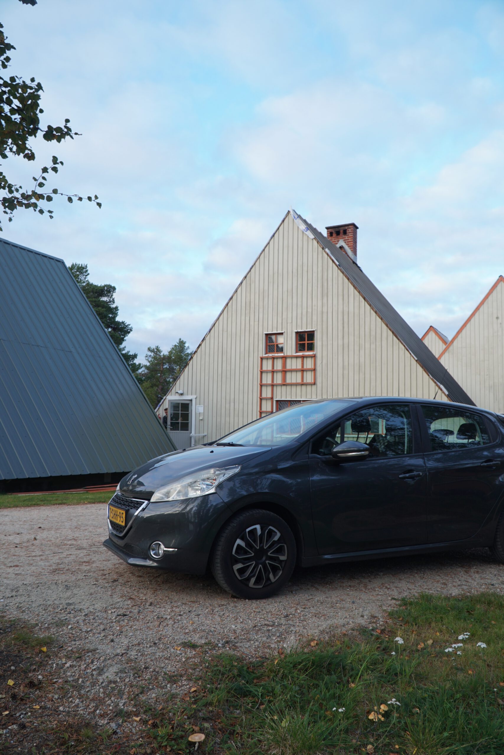 Hetan Kota Enontekiö Finland triangular cabin accommodation with parked car, iconic Lapland architecture in quiet wilderness setting