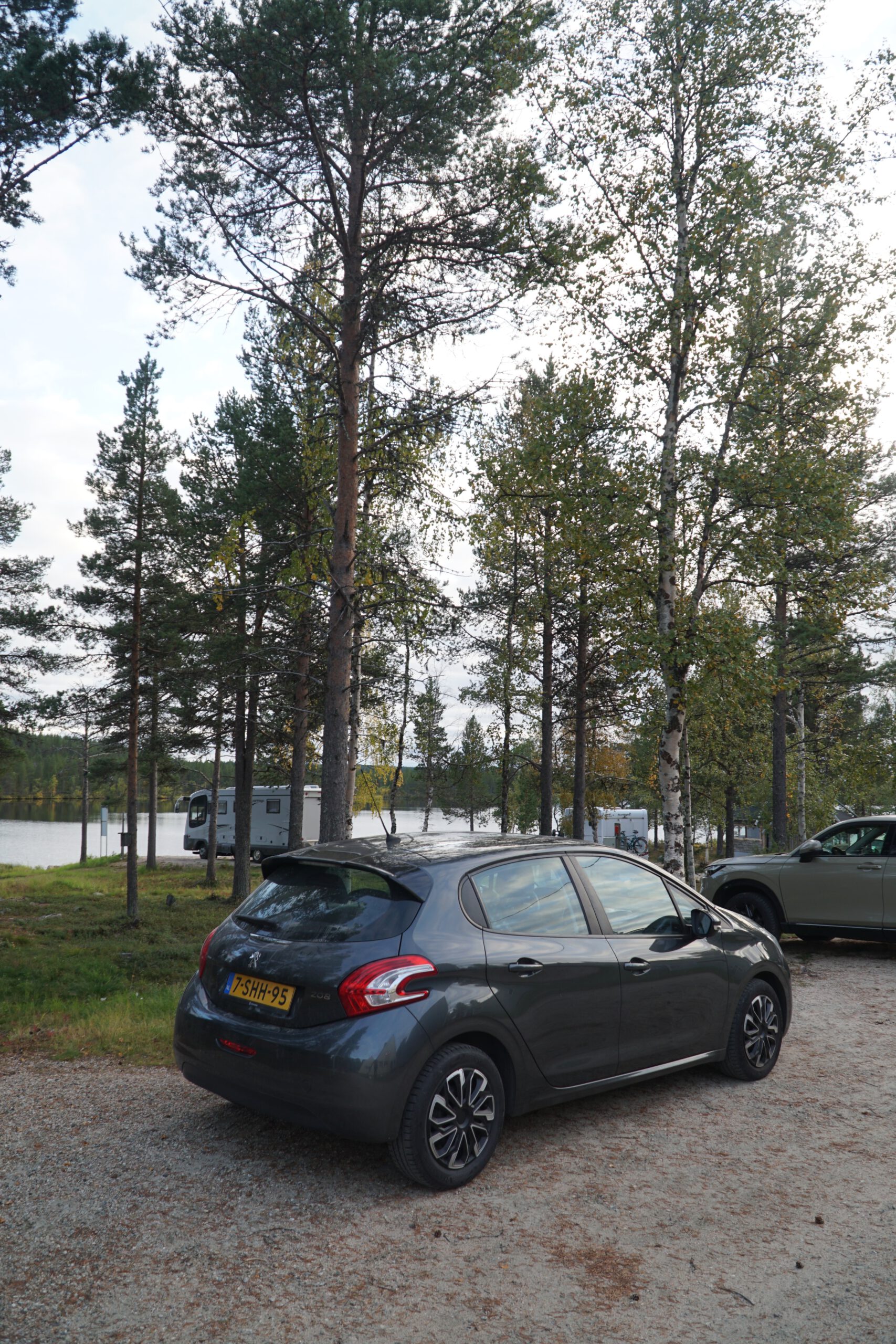 Hetan Kota Enontekiö Finland parking area with Peugeot 208 (2013 model) surrounded by forest and lake, remote Lapland accommodation in complete silence