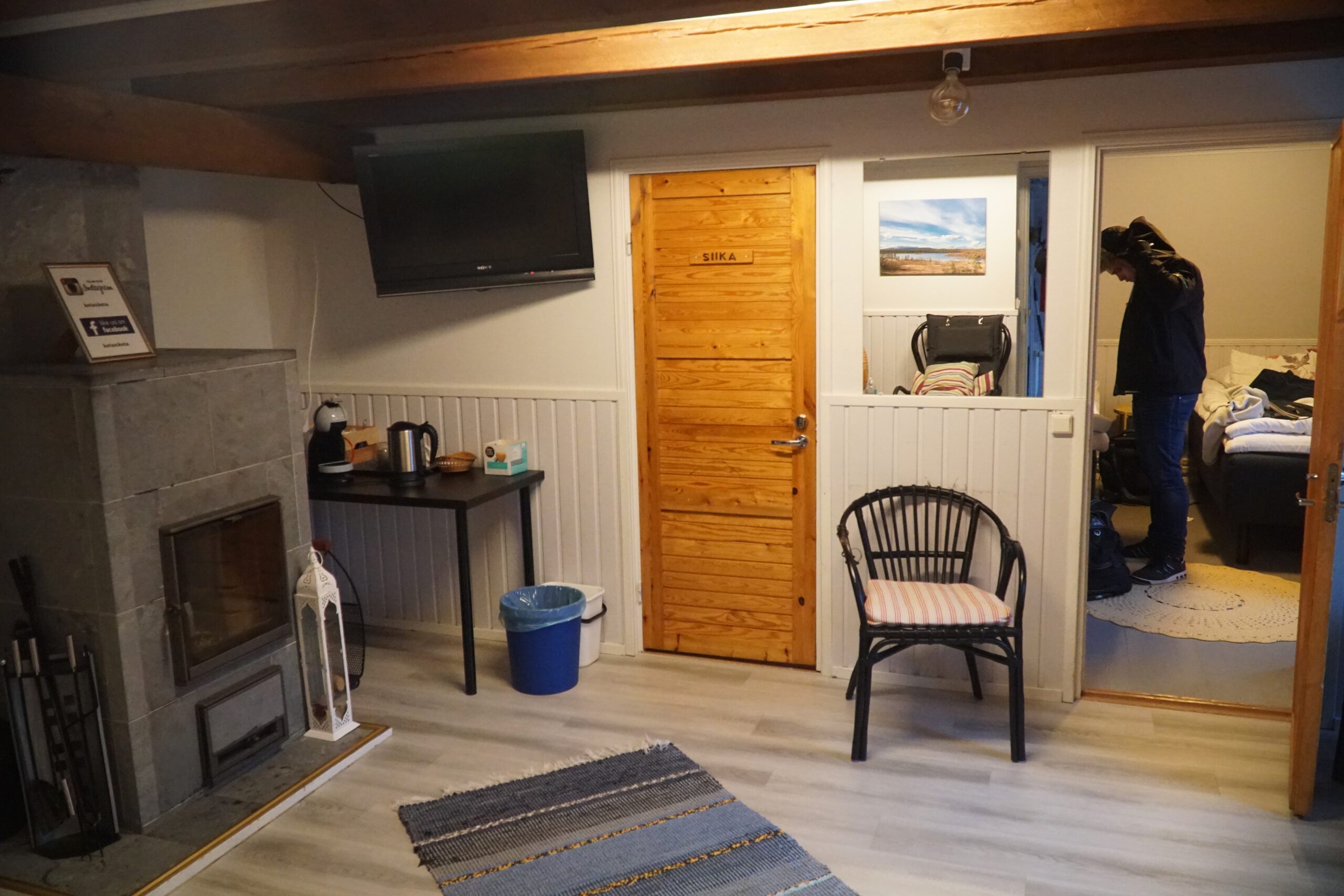 Hetan Kota Enontekiö Finland cozy interior with shared living space, wooden details, fireplace, and simple Scandinavian cabin atmosphere
