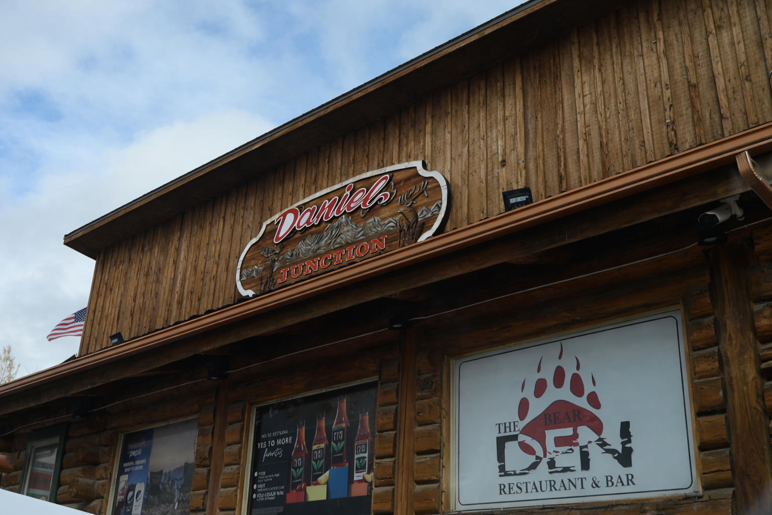 Exterior of Daniel Junction Wyoming featuring the Bear Den Restaurant and Bar, a popular gas station stop with food and lodging in Daniel Wyoming