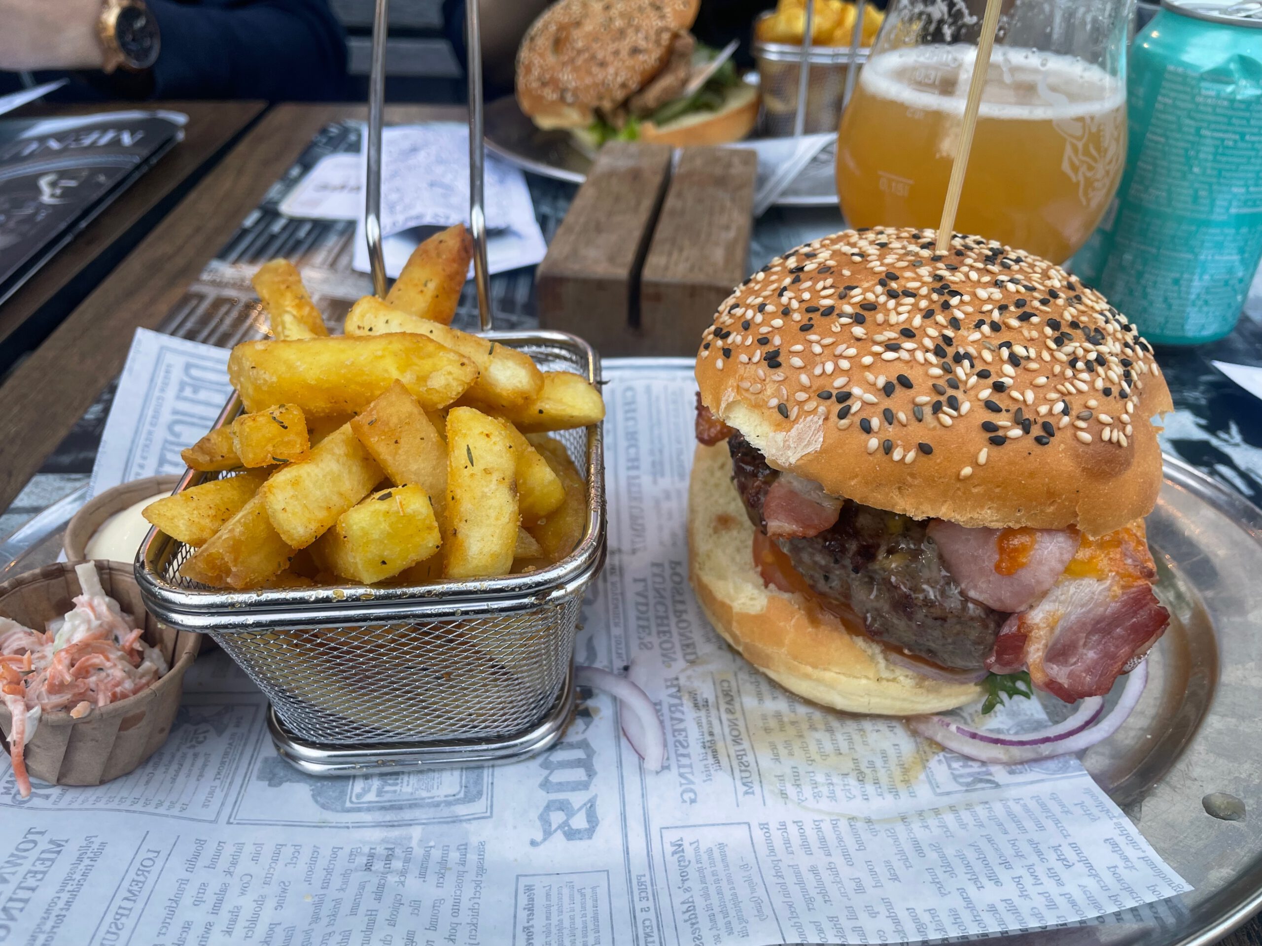 De Brabantse Aap Amsterdam bacon burger served with fries on the terrace, classic pub food experience