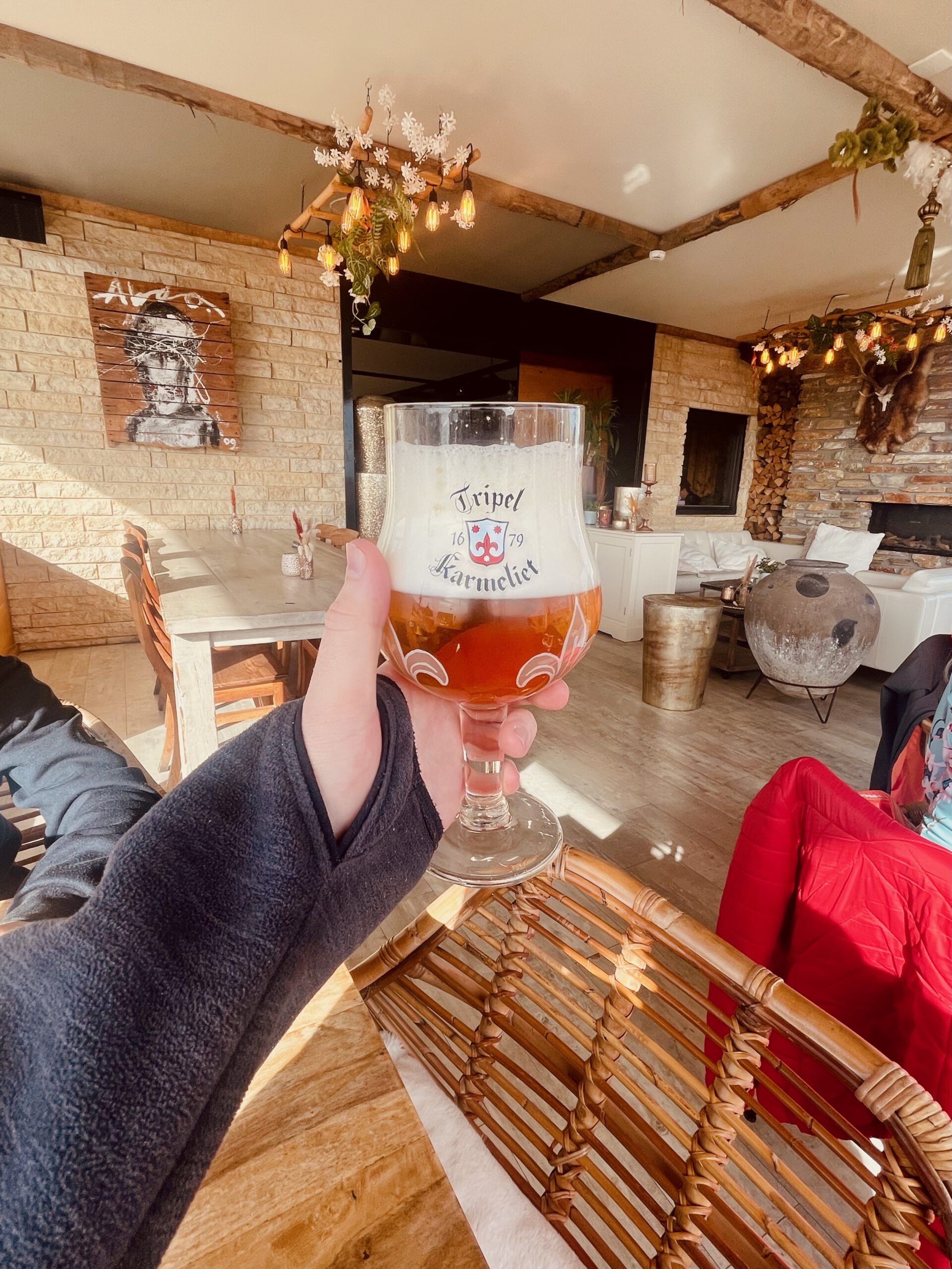 Belgian Tripel Karmeliet beer served inside Strandrestaurant Nederzandt Noordwijk, a full bodied blonde tripel enjoyed after a beach walk