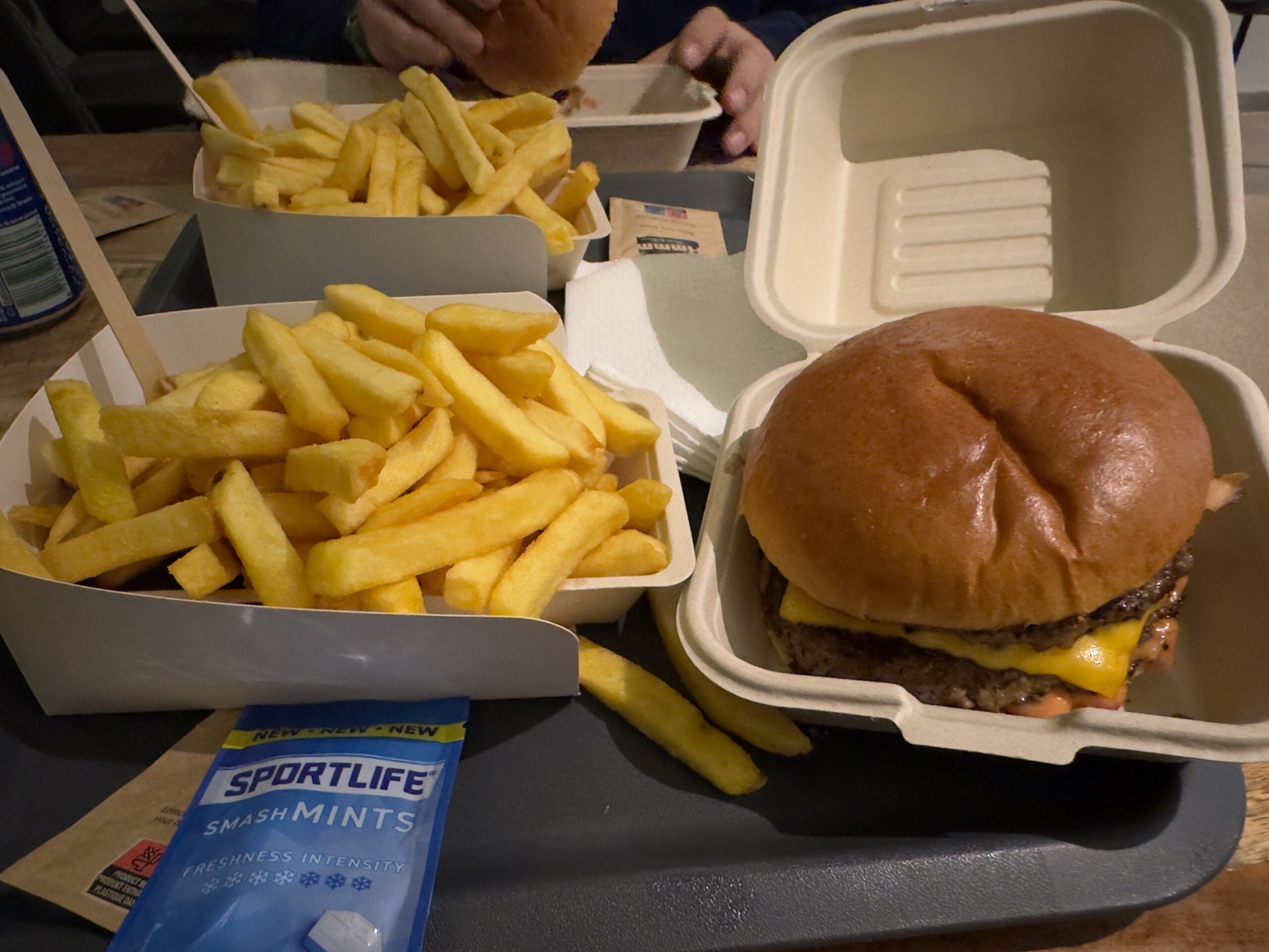 Smash burger with melted cheddar and crispy fries served at Barry’s Eethuis Makkum, a popular local snack bar in Friesland near the Afsluitdijk