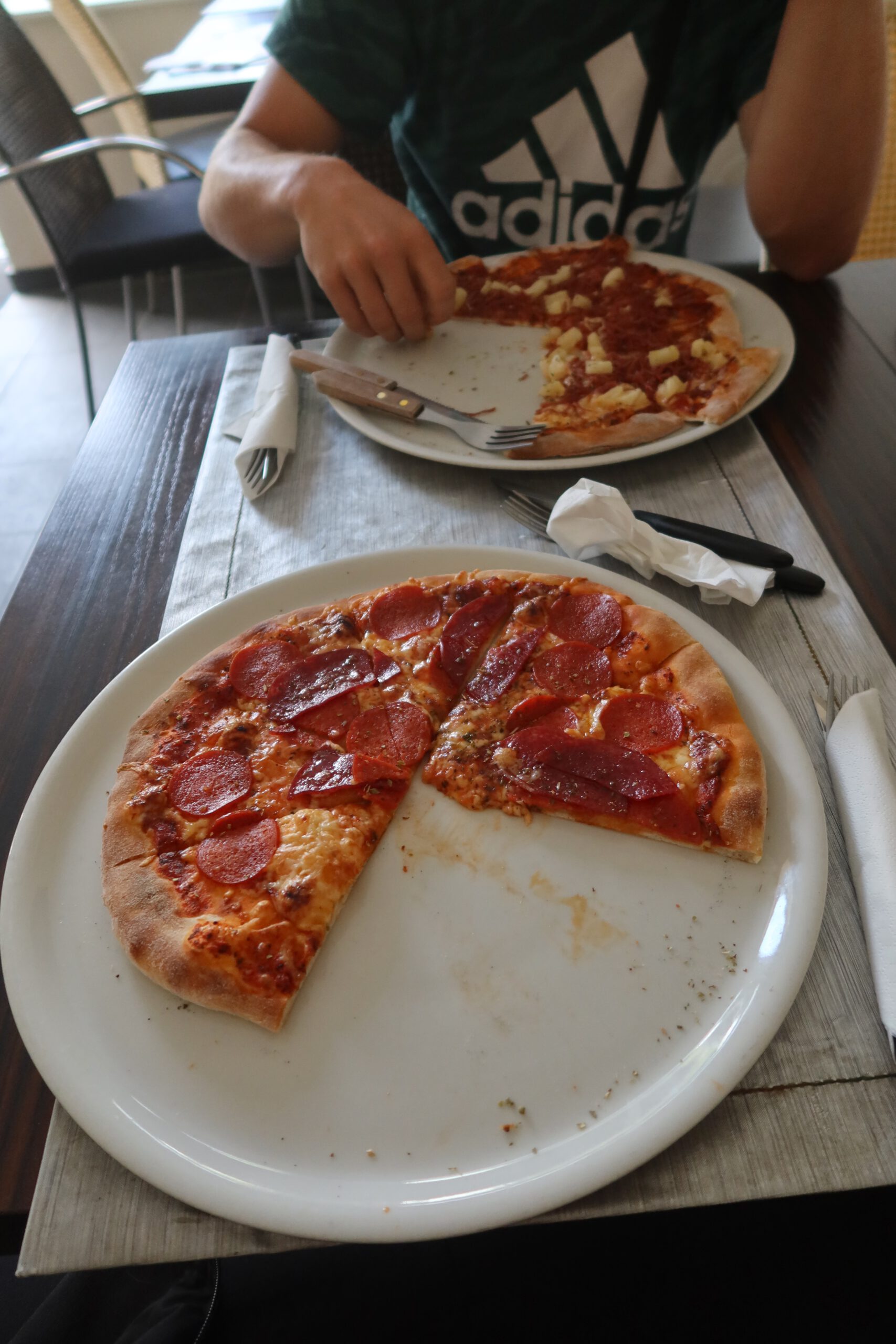 Pizza lunch at Menu Pizzeria & Grill Kruså, fresh pepperoni pizza served during a quiet road trip stop