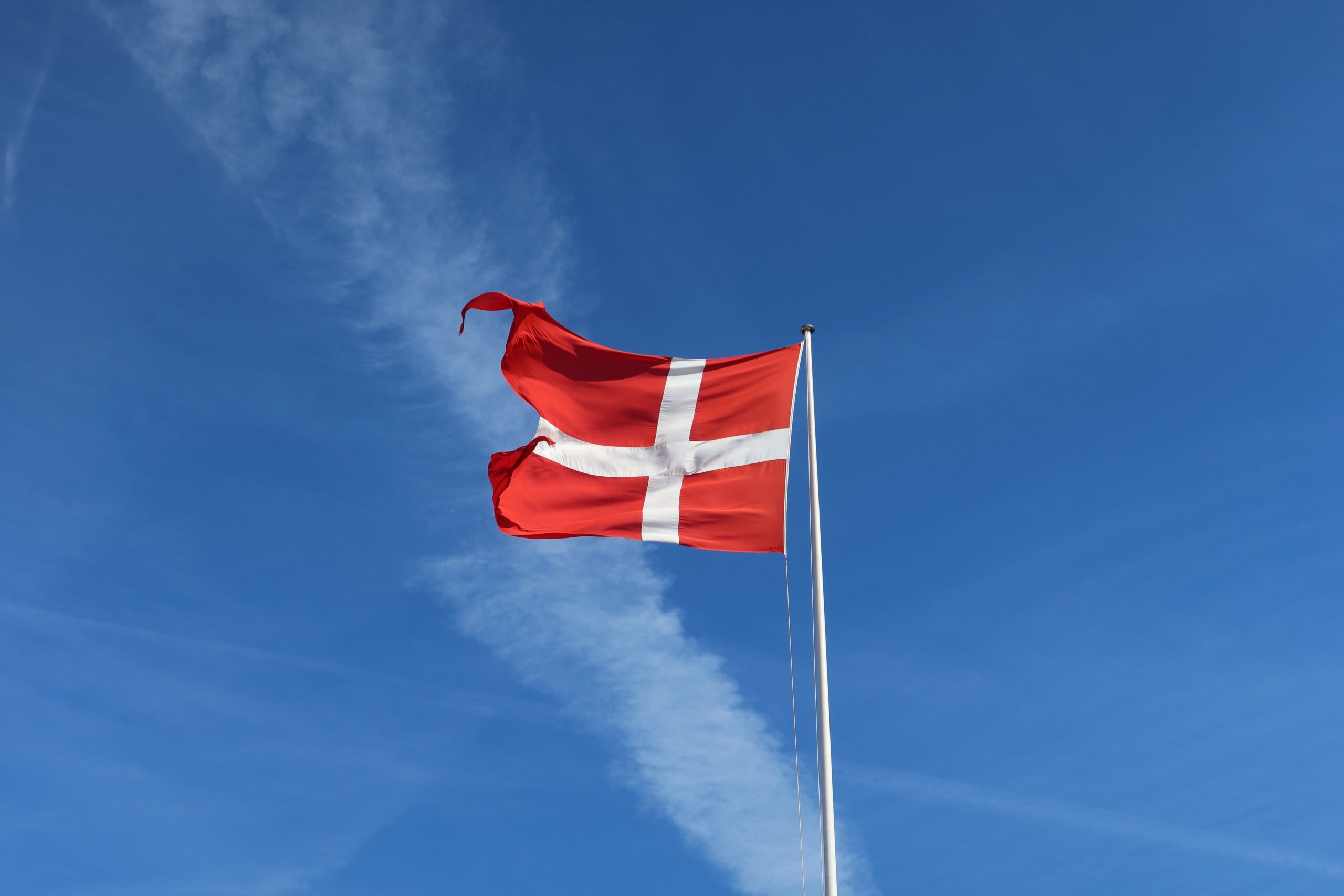 Kastellet Copenhagen Danish flag flying above the historic star fortress under a clear blue sky