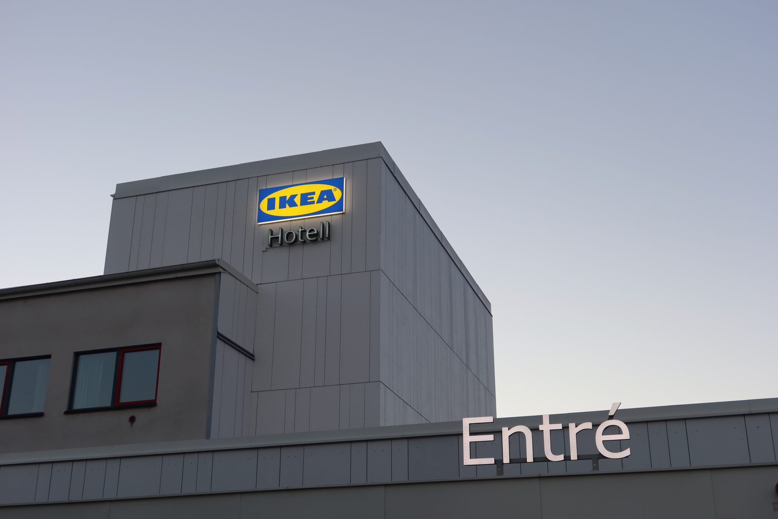 IKEA Hotell Älmhult exterior entrance with iconic IKEA logo at dusk in Sweden