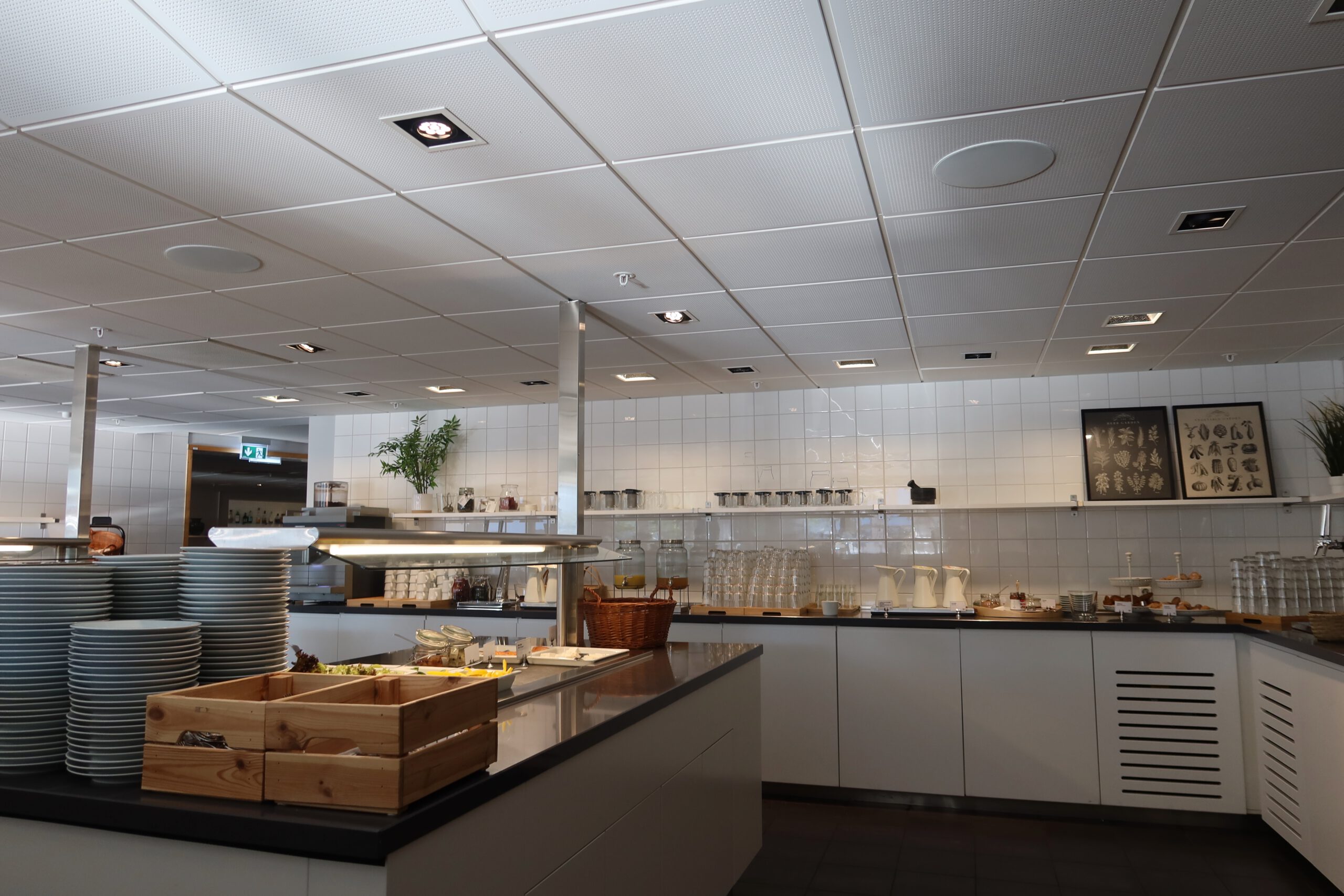 Breakfast buffet at IKEA Hotell Älmhult featuring a clean Scandinavian setup with plates, glassware, bread, spreads and drinks in a bright dining area.