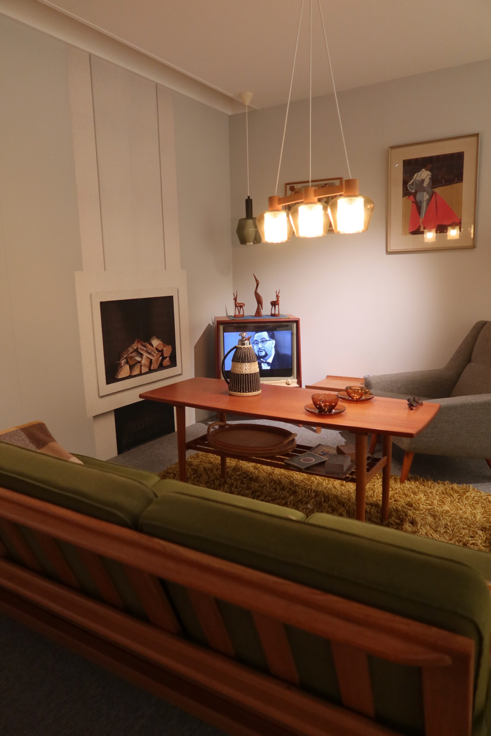 IKEA Museum Älmhult interior, vintage living room setting with classic IKEA furniture and warm Scandinavian design