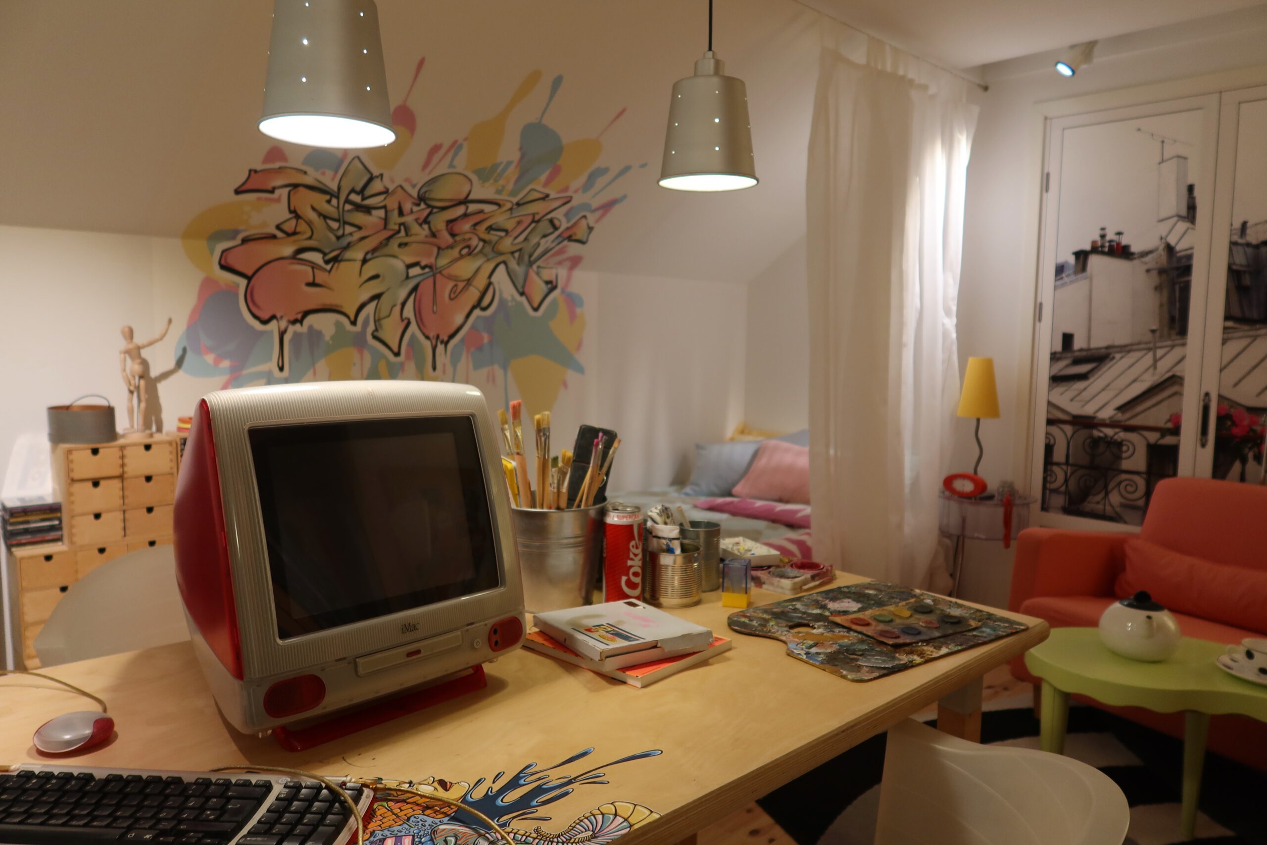 Creative studio style room with colorful decor and vintage iMac at the IKEA Museum Älmhult, highlighting playful and innovative IKEA interiors