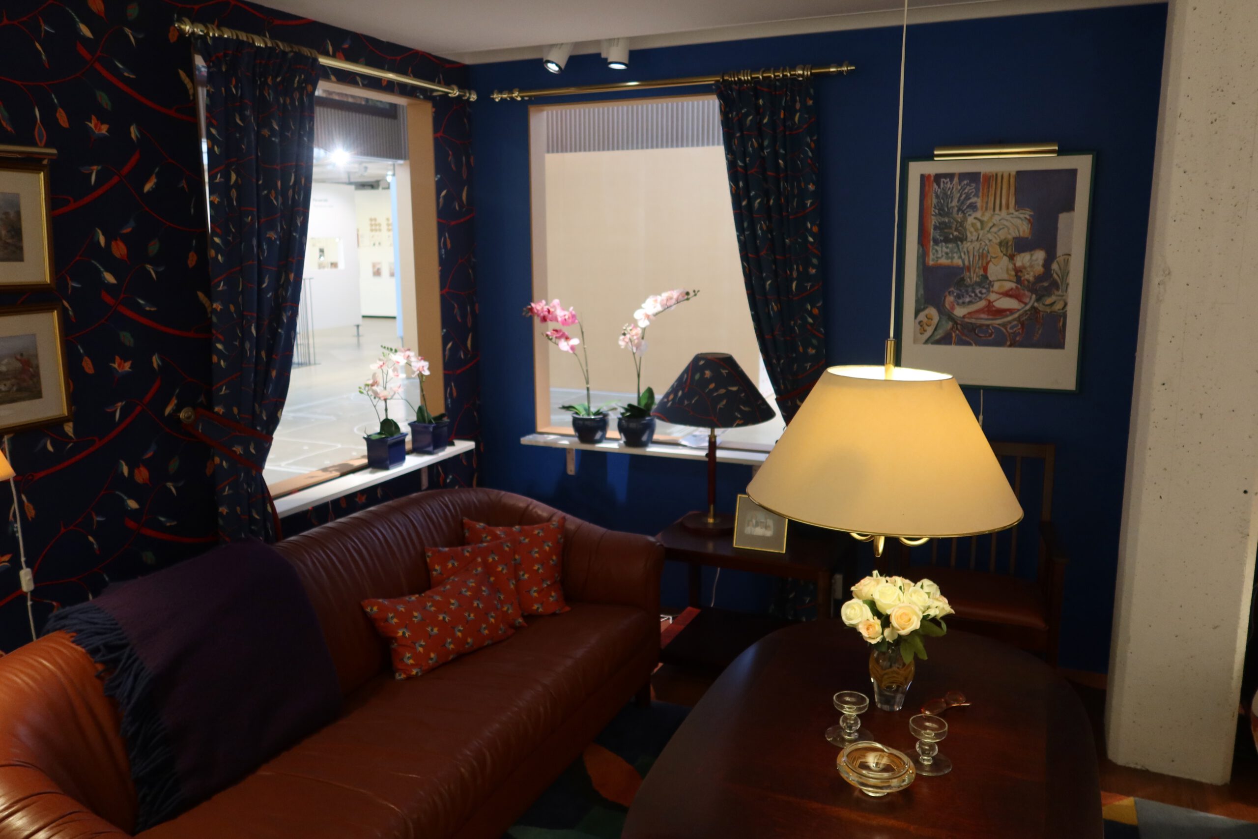 Stylish dark blue living room with leather sofa and classic decor inside the IKEA Museum Älmhult, reflecting timeless Scandinavian home design