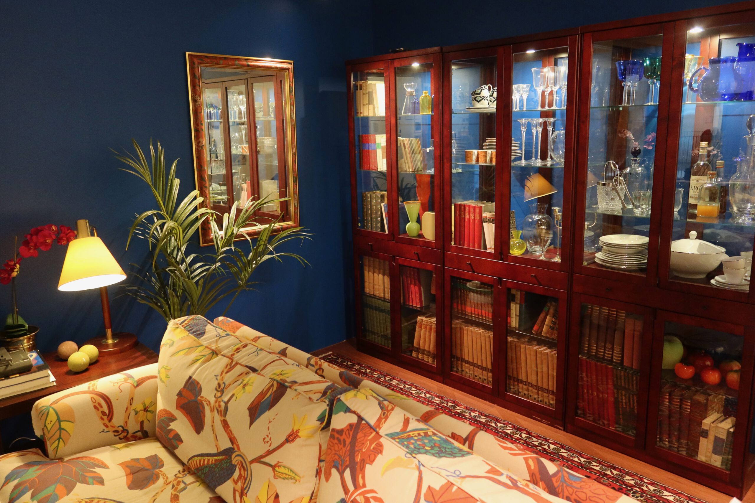 Vintage living room display with classic IKEA furniture and glass cabinets at the IKEA Museum Älmhult, showcasing Scandinavian interior design history