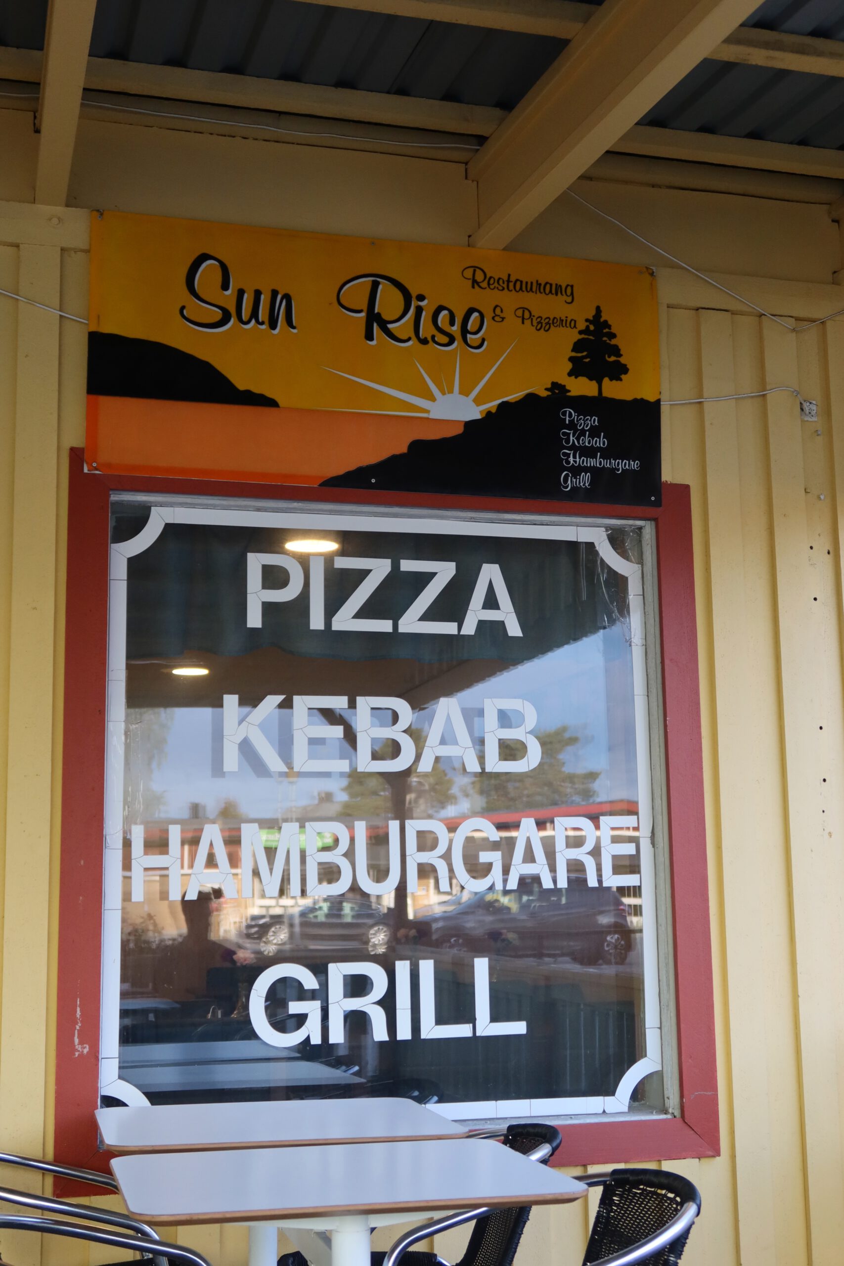 Sun Rise Nordmaling restaurant sign and window showing pizza kebab hamburger grill menu at a small town pizzeria in northern Sweden